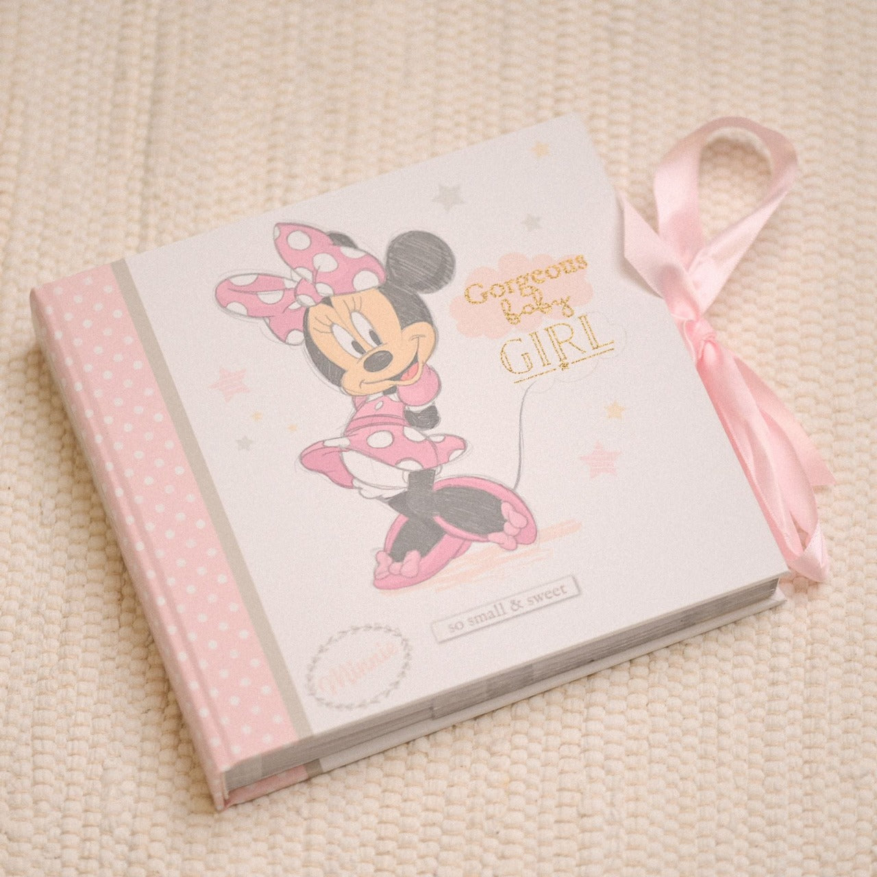 Disney Magical Beginnings Photo Album 4" x 6" Minnie Mouse  Add a touch of magic to your every day with this Magical Beginnings Photo Album.  As part of our range of classic Disney illustration giftware, this photo album displays a beautiful depiction of the classic Disney character, Minnie Mouse, 'Gorgeous Baby Girl' gold glitter lettering and space for fifty 4" x 6" photos.