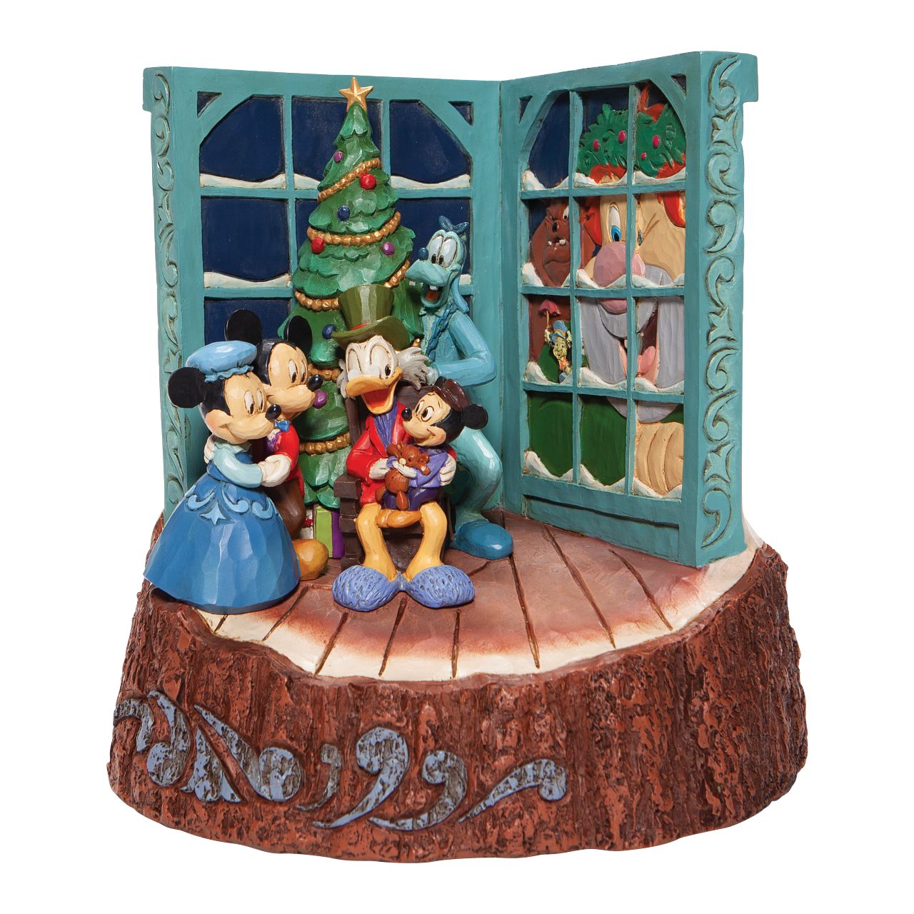 Jim Shore Mickey Mouse Christmas Carol Carved by Heart Figurine  Mickey and family gather around the tree to witness a Christmas Carol retelling by Scrooge McDuck. With windows alight with narrative imagery, they're in for a treat celebrating Christmas past, present and future in this nostalgic design by Jim Shore.