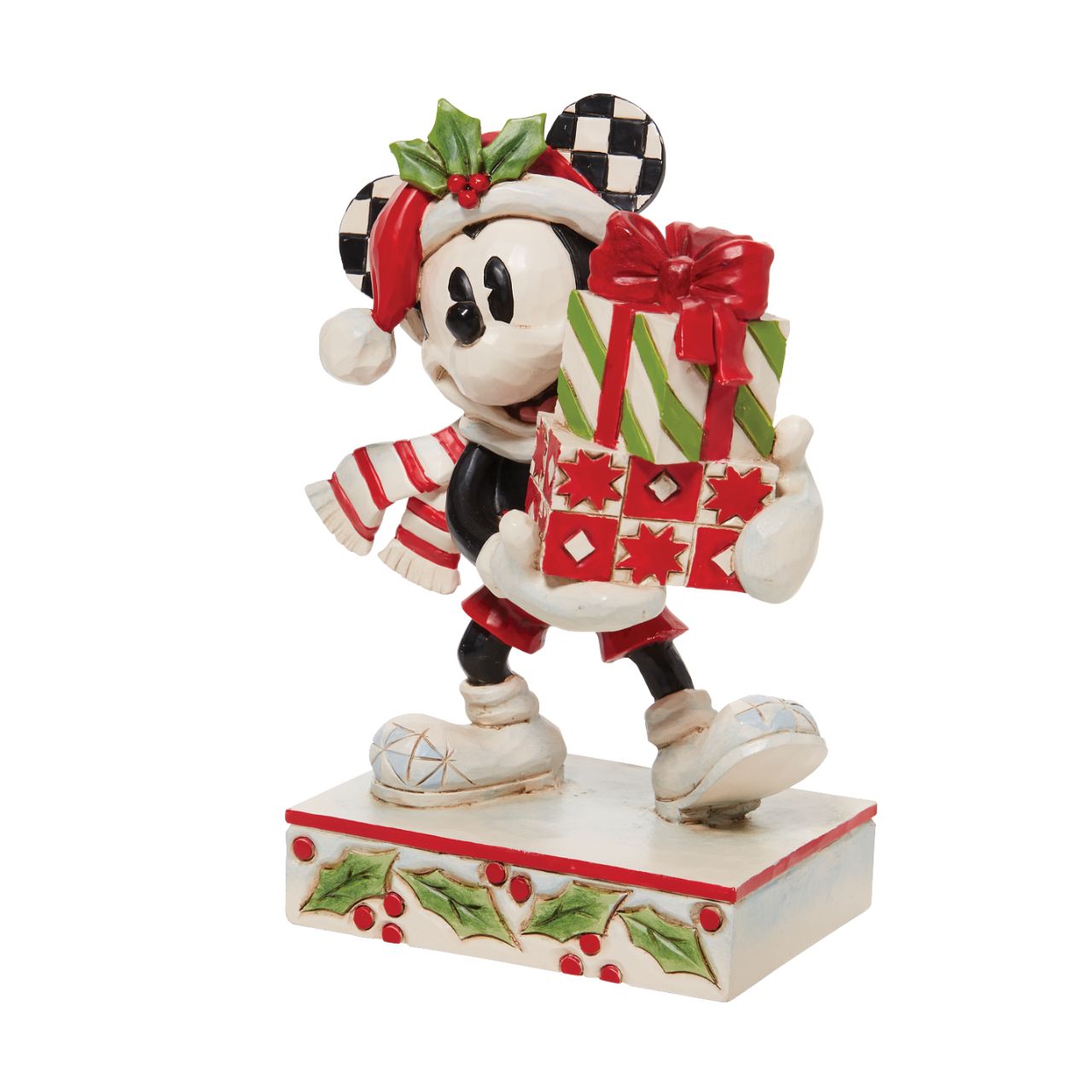 Jim Shore Christmas Mickey with Stack of Presents Figurine  Disney comes home for the holidays with this festive figurine by Jim Shore. Donning a candy cane striped scarf, Mickey wears a neighborly smile as he carries a towering stack of presents. The cheerful mouse boasts a holly brimmed Santa hat.