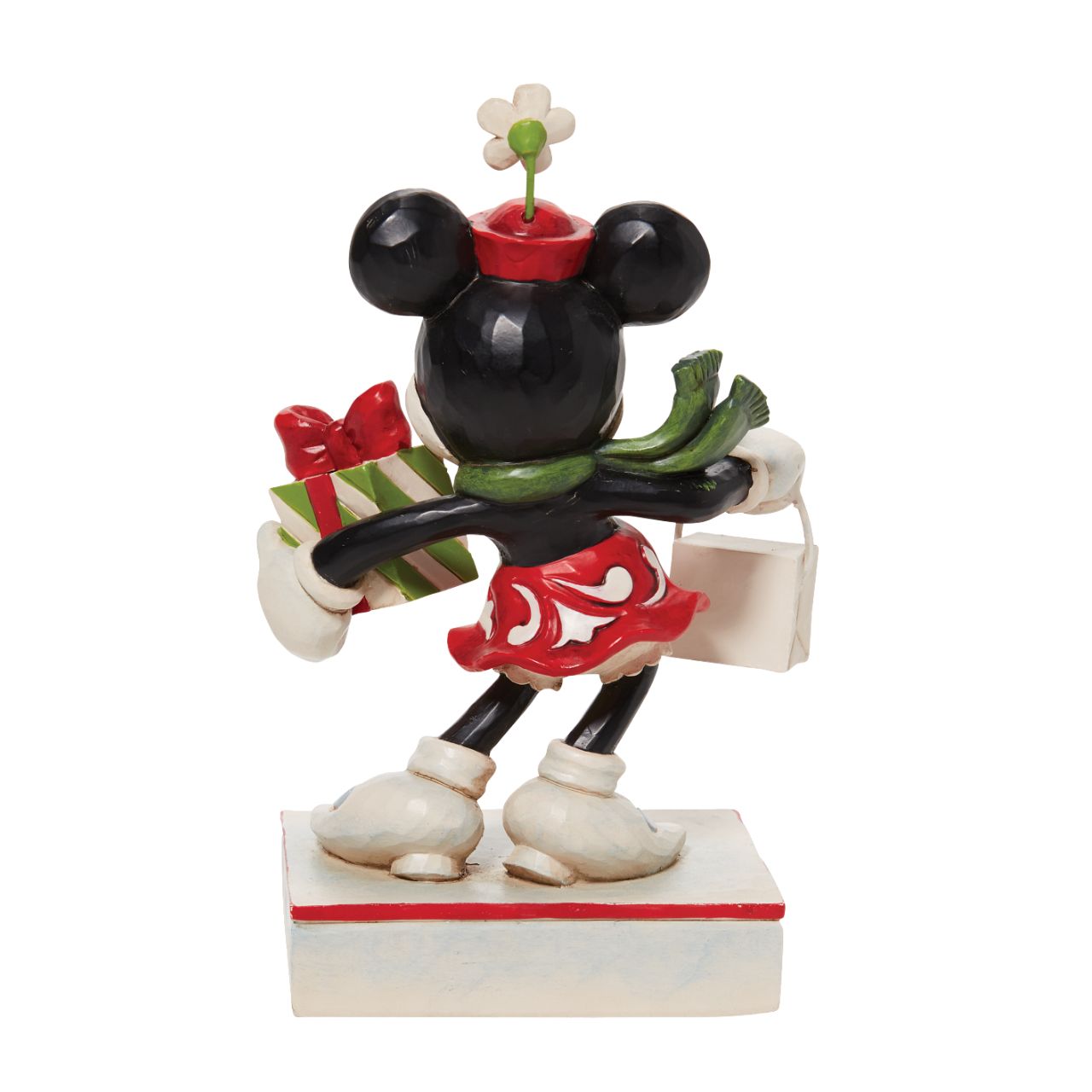 Jim Shore Christmas Minnie with Bag and Present Figurine  Disney comes home for the holidays with this festive figurine by Jim Shore. Minnie Mouse is an icon of fashion and friendliness this year as she completes her Christmas shopping. Boasting with bags, she's eager to share the giving spirit with you.