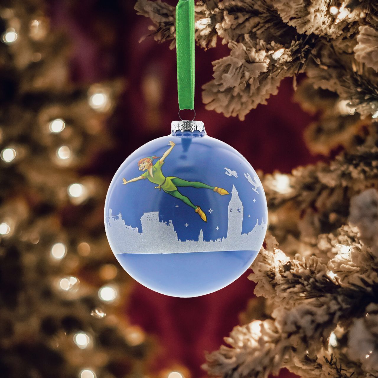 Disney Christmas Bauble Peter Pan You Can Fly  Peter Pan flys above the silhouette of London with Wendy and the boys in this beautiful glass bauble. This treasured keepsake would make a lovely unique gift for a friend, or a self-purchase to brighten up the home.