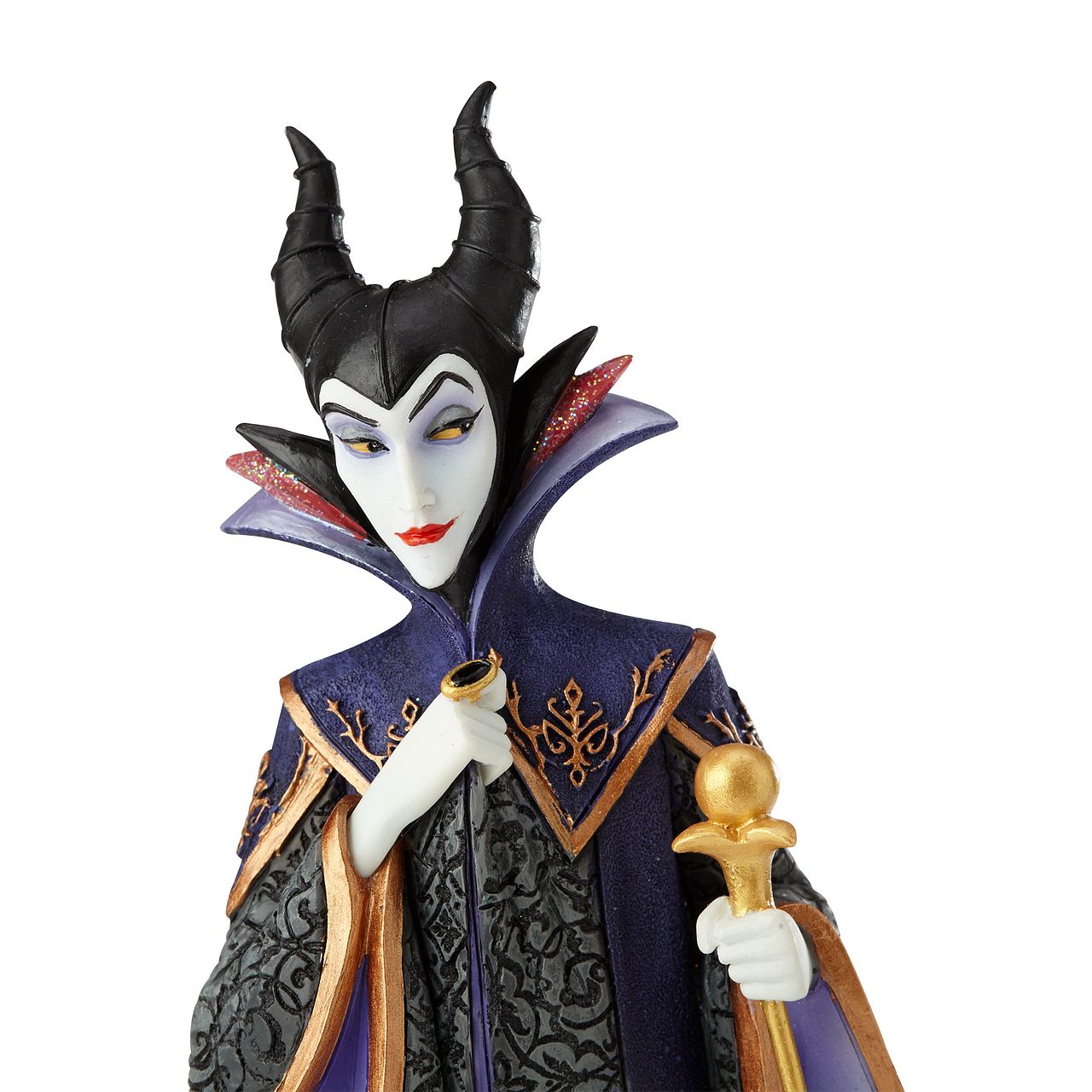Disney Maleficent Figurine  Maleficent strikes a regal pose in this handcrafted design from the Haute Couture collection, her ominous onyx robes reimagined as a satin gown and feathered, floor-length cape. Ready to rule the runway, the fashionable figure holds a golden scepter.