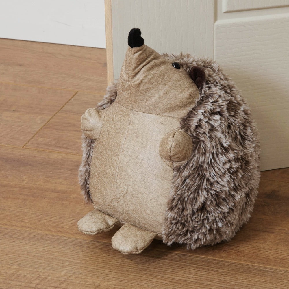 Home Living Door Stopper - Beige Hedgehog  Bring some warmth and charm to any room with this distressed beige faux leather hedgehog door stop. From the Nature Trail collection by HESTIA® - bring some subtle Spring vitality to your home.