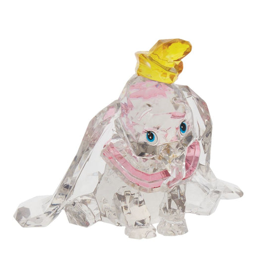 Dumbo Facets Figurine  This "gem cut" acrylic sculpture reflects the ninth wonder of the universe. The world's only flying elephant. Dumbo is already for his circus debut with his yellow hat and pink collar. Presented in a branded window gift box.
