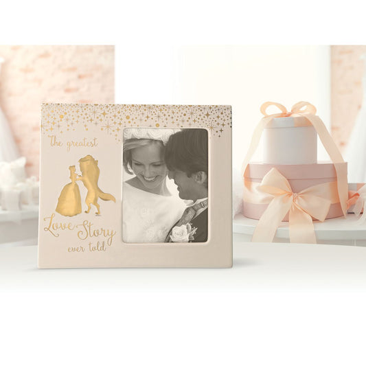 Enchanting Disney Belle Wedding Photo Frame  This magical photo frame holds a 5 x 4 photo, perfect to show off your greatest love story. Beauty and the Beast are featured in gold relief. Packed in a Disney branded window gift box. Not a toy or children's product. Intended for adults only.