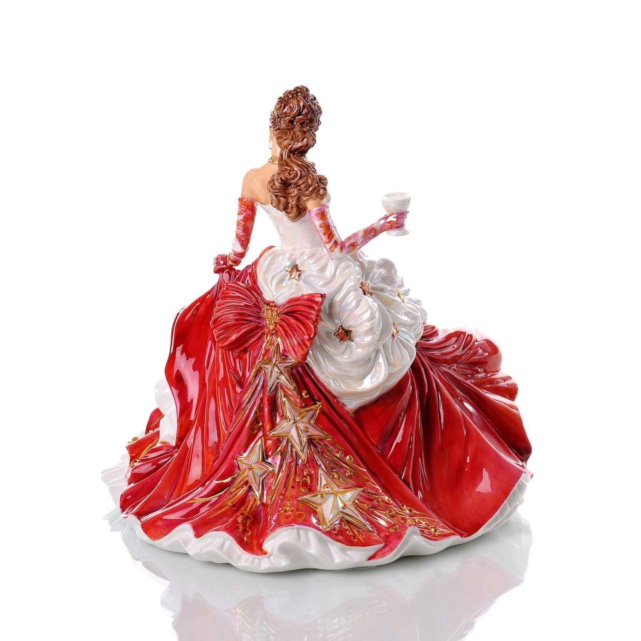 English Ladies Congratulations Ruby  With all her trademark flair and frills, Valerie has created the perfect canvas for Dan to show off his prodigious decorating skills, garnered over 40 years as a Prestige Painter at Royal Doulton.  Dan has pushed the boundaries on mixing colours to achieve previously unseen finishes, first on our beautiful Congratulations Gold figurine and now on this wonderful Ruby colourway.
