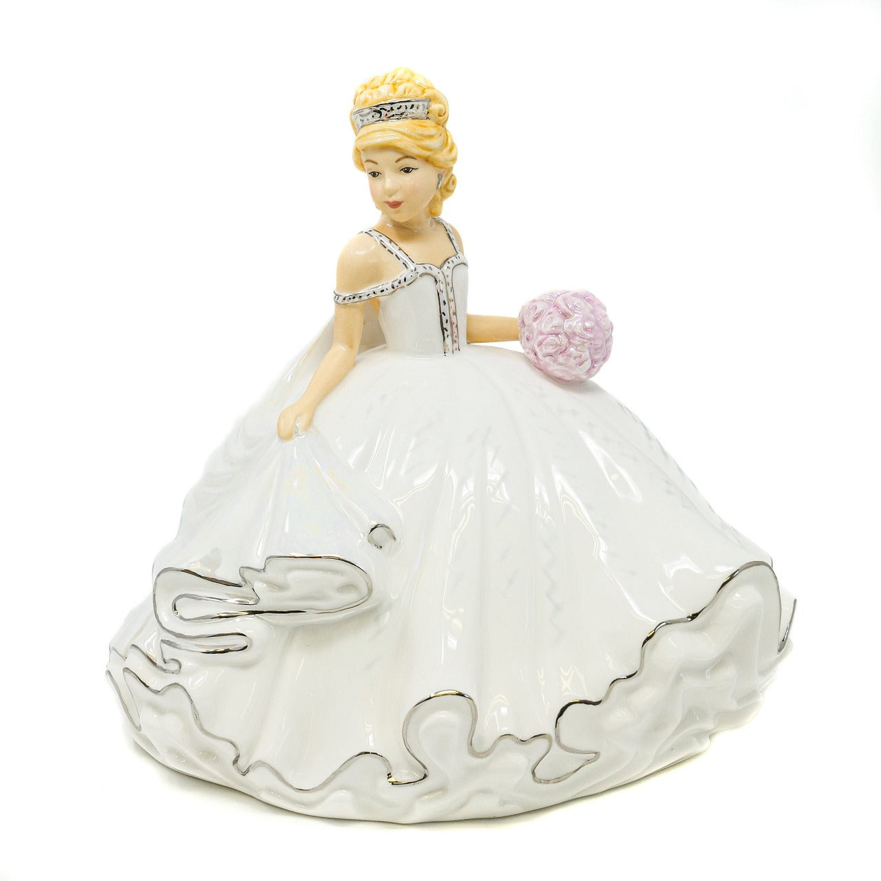 English Ladies Mini Bride of the Year Blonde  This figurine is the Mini version of the very popular Thelma Madine Bride of the Year. Standing at approximately 20cm tall the Mini Bride of the Year Blonde is dressed in a beautiful gown decorated in Mother of Pearl Lustre and real platinum highlights.