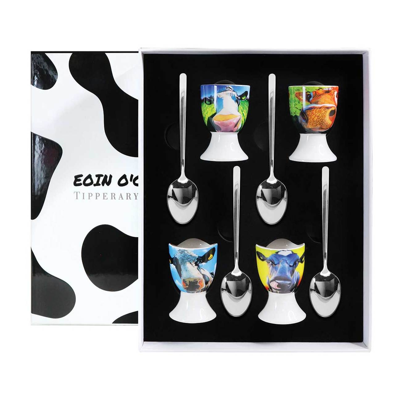 Eoin O'Connor Cow Egg Cup Set of Four  EOIN O’CONNOR’S eclectic style and striking use of colour makes his work instantly recognisable. While his command over scale and perspective is rooted in his architectural training, his passion remains firmly grounded in creating strikingly vibrant paintings which echo his unique view of Irish life.