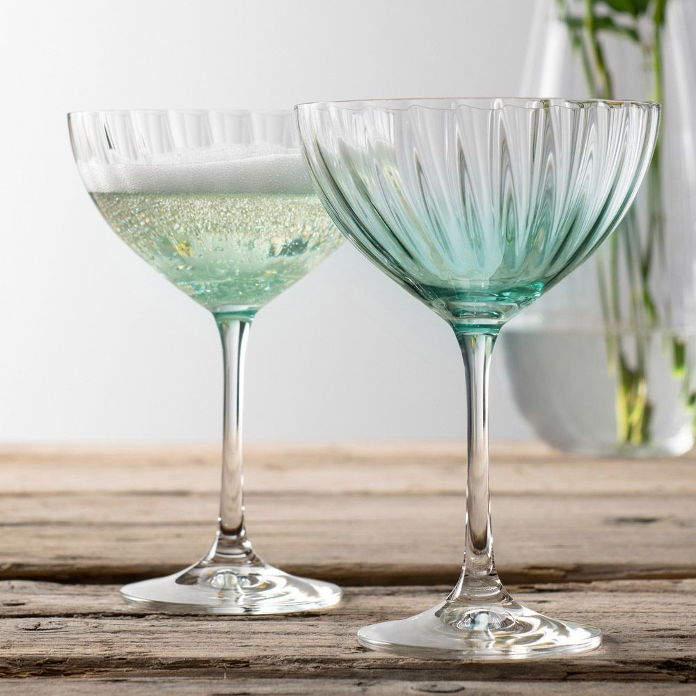 Erne Saucer Champagne Glass Pair Aqua by Galway Crystal  These beautifully crafted Galway Crystal Champagne saucers with an Amber coloured base are beautiful glasses for your home. The elegant shape of the glass along with the Erne pattern displays light lines along the body adding a stylish and modern finish.