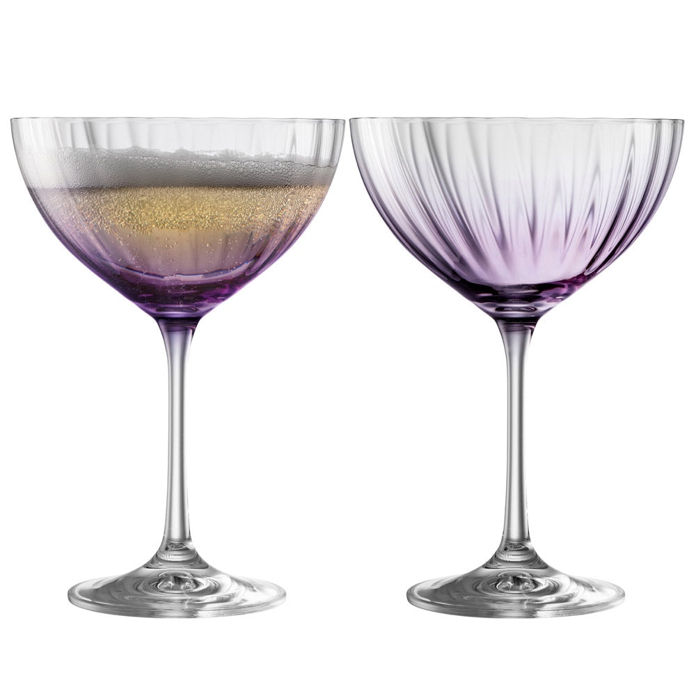 Galway Crystal Erne Saucer Champagne Glass Pair Amethyst  These beautifully crafted Galway Crystal Champagne saucers with an Amethyst coloured base are beautiful glasses for your home. The elegant shape of the glass along with the Erne pattern displays light lines along the body adding a stylish and modern finish.