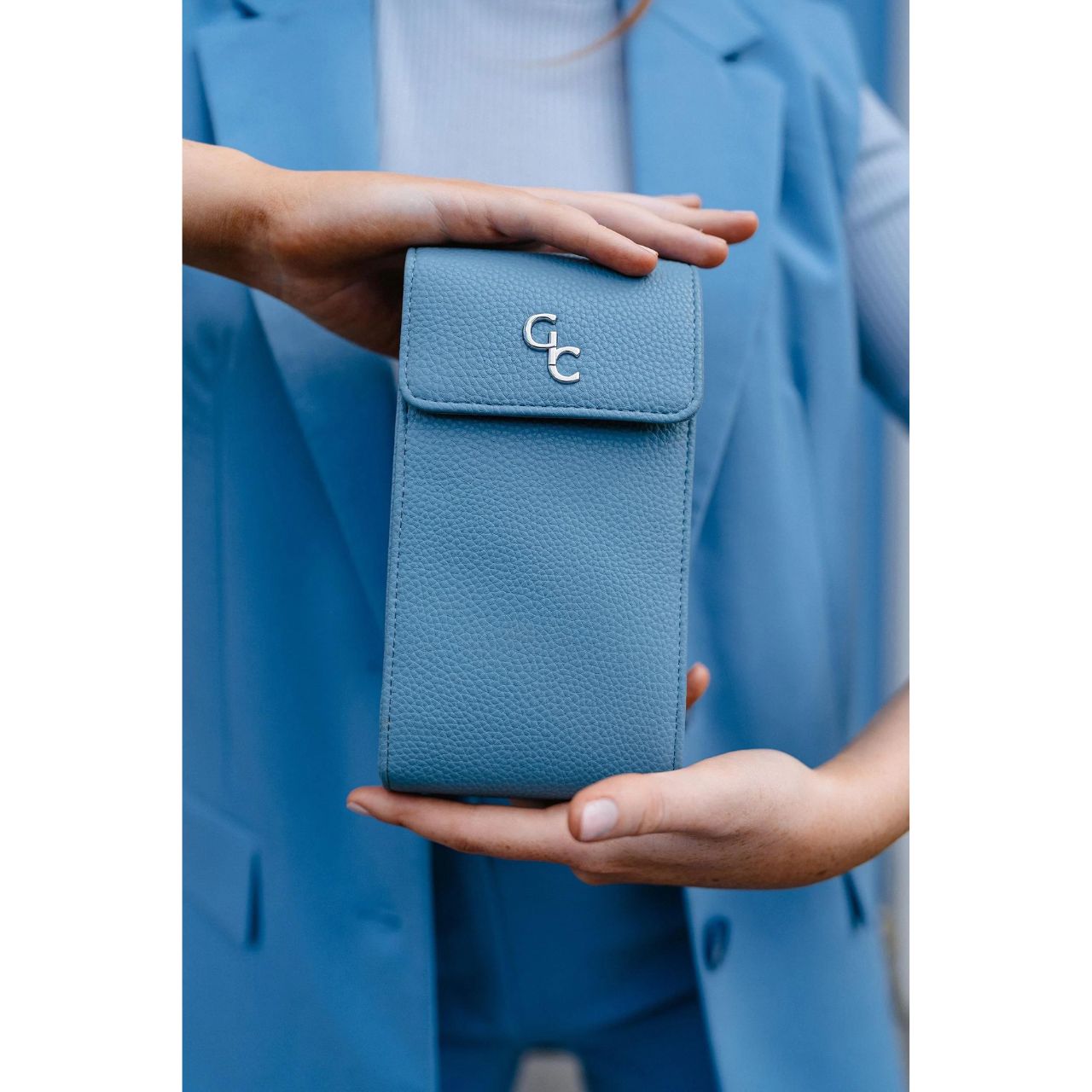 Mini Cross Body Bag - Light Blue by Galway Crystal  Introducing the new must have accessory that is truly functional. Our Light weight, Slim, Sleek, Crossbody bag is designed to hold the most essential accessory: Your mobile phone. There is nothing more liberating than carrying a lightweight bag that carries your essentials.