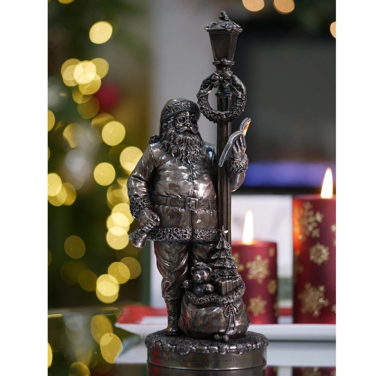 Genesis Ireland Santa's Check List  A stunning ornament that is sure to bring festive cheer to your home, beautiful bronze coloured Christmas decoration, by Genesis Ireland.  Depicting Santa Claus checking his list before setting of on Christmas Eve. Have you been Naughty or Nice? Let the magic of Christmas fill your home with this gorgeous sculpture for many years to come.