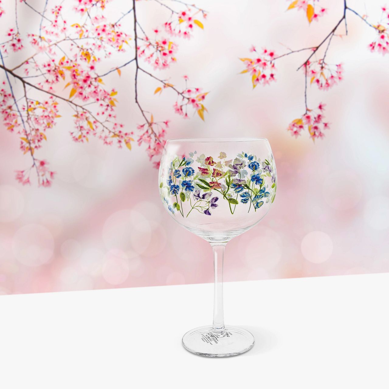 Ginology Sweet Pea Copa Gin Glass  A beautiful vintage style gin glass featuring pretty sweet peas in pinks, blues and purple. A loving gift of appreciation for someone special, pair with a fragrant floral gin for a gift full of sweetness.