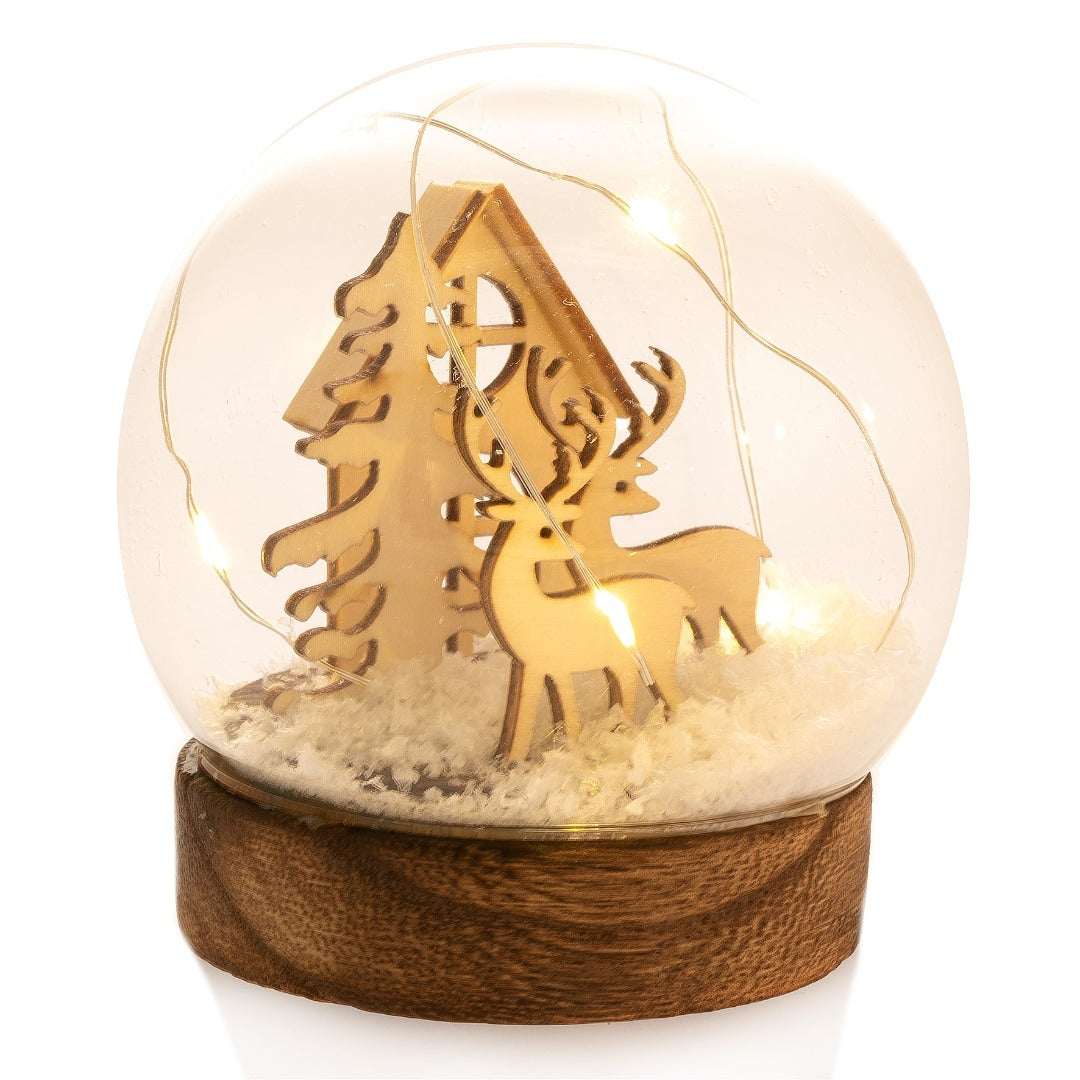 Glass Dome with Wooden Reindeers, Tree and House LED  Imagine a walk through a dense dewy fir forest on a crisp winter morning. 