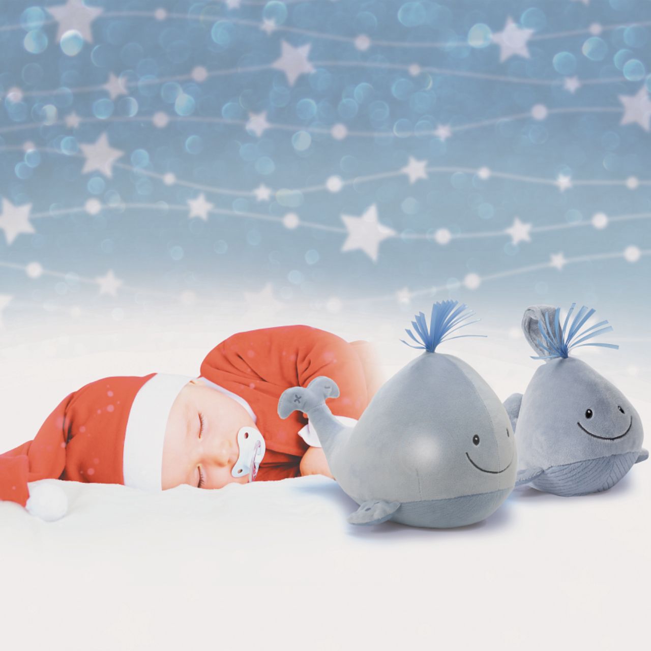 GUND Baby Sleepy Seas Light & Sound Whale - Small  This musical plush toy will help your babies drift off to sleep. The whale is presented in an oh-so-soft light blue fabric, with blue ribbons for its hair, and dark embroidery creating a smiling face. Press the left fin and the animated whale splashes into life. Press the musical note on its right fin and the plush starts to play one of five different noises: