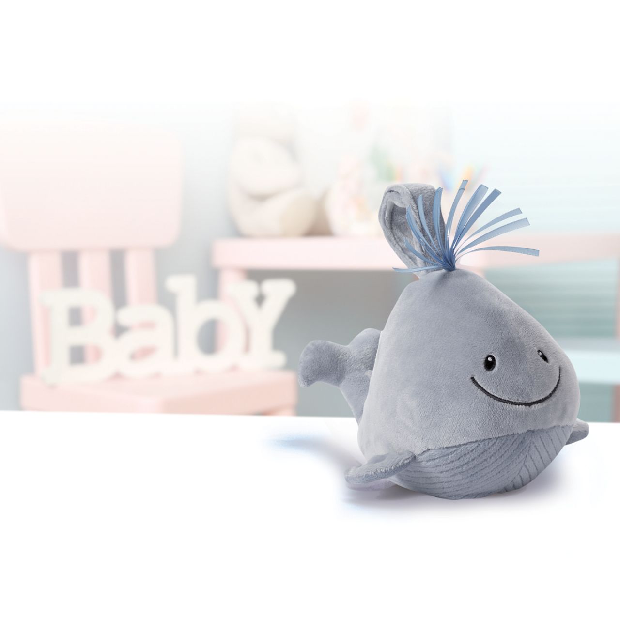 GUND Baby Sleepy Seas Light & Sound Whale - Small  This musical plush toy will help your babies drift off to sleep. The whale is presented in an oh-so-soft light blue fabric, with blue ribbons for its hair, and dark embroidery creating a smiling face. Press the left fin and the animated whale splashes into life. Press the musical note on its right fin and the plush starts to play one of five different noises: