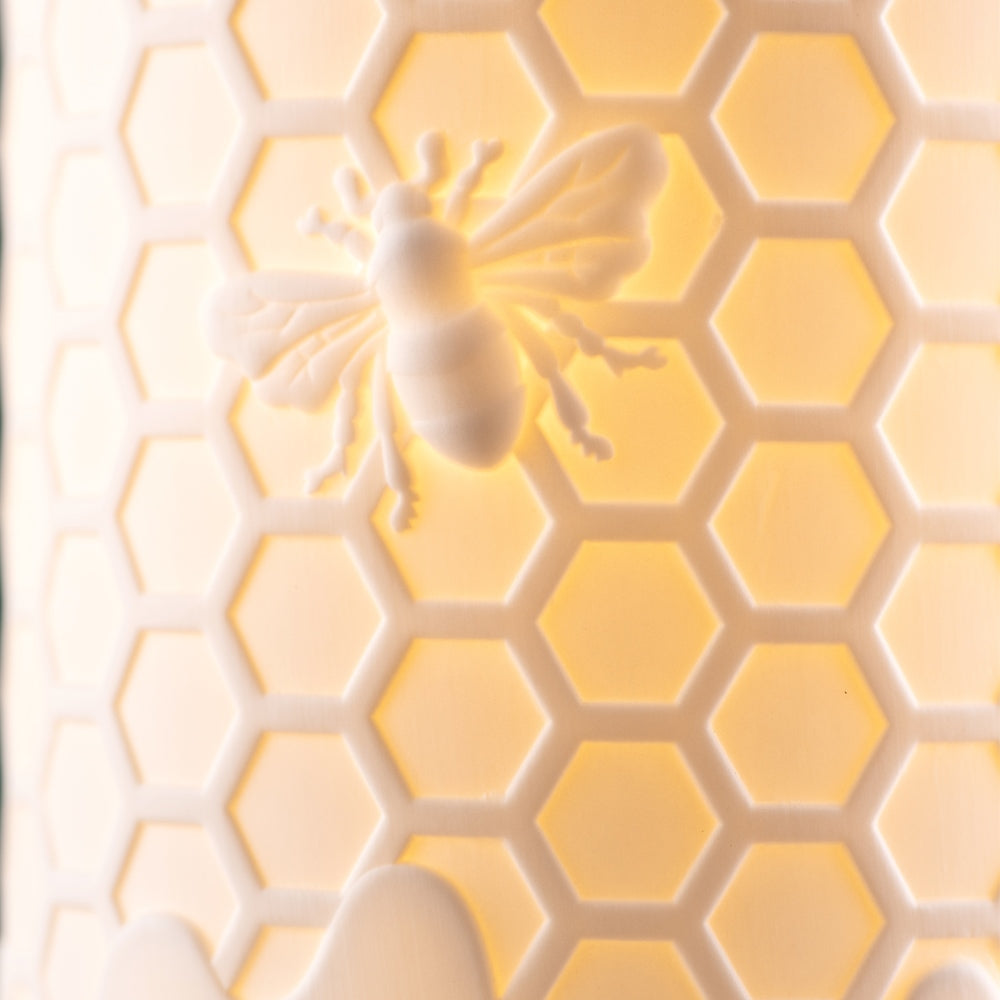 Honey Hive Luminaire by Belleek Living  The Honey Hive Luminaire features beautifully modelled details, with a hexagon hive pattern and a little embossed bee. Belleek Living Luminaire lamps emit a soft warm glow highlighting the delicate surface decoration, creating beautiful mood lighting for your home.