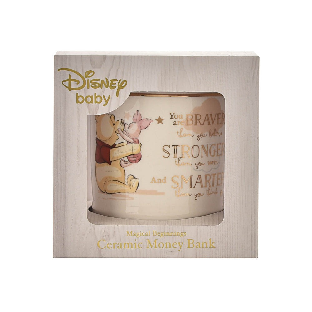 Disney Magical Beginnings Ceramic Money Box Bank - Winnie the Pooh  Evoke the magic of Disney with this Winnie The Pooh money bank.  As part of our Disney Magical Beginnings range, this beautiful money bank features an original sketch of Winnie the Pooh and Piglet, with the sentiment 'You are braver than you believe, stronger than you seem and smarter than you think' in gold foil lettering.