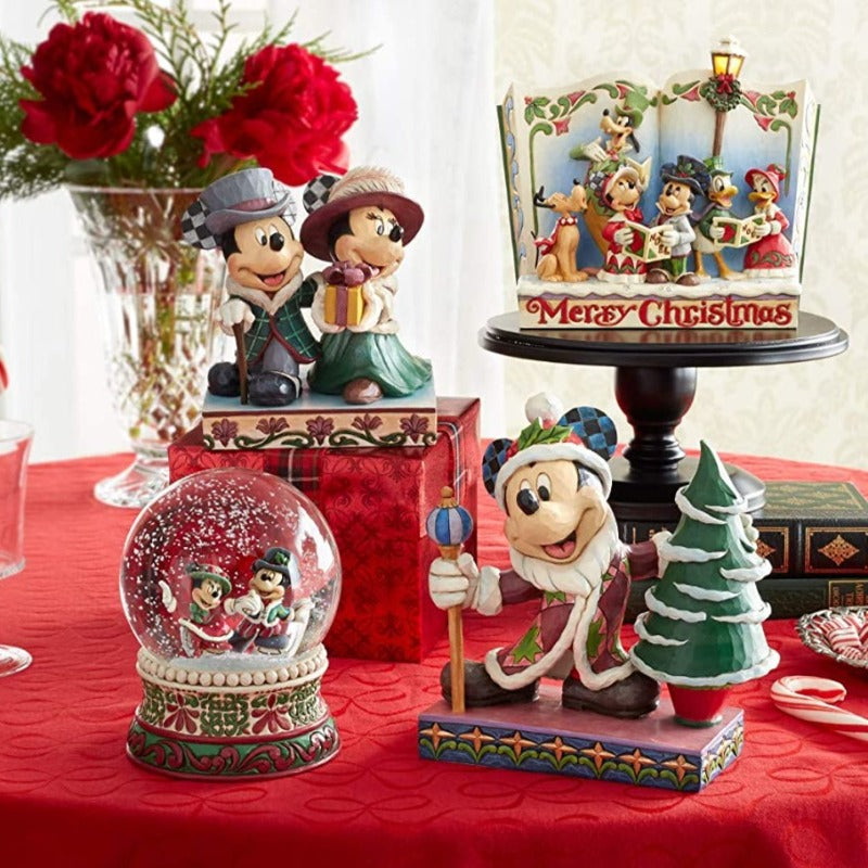Jim Shore Merry Christmas (Christmas Carol Storybook)  Mickey and friends joyfully celebrate the season by caroling throughout the town. This festive piece by Jim Shore combines the magic of Disney with time-honored motifs of handcrafted folk art.
