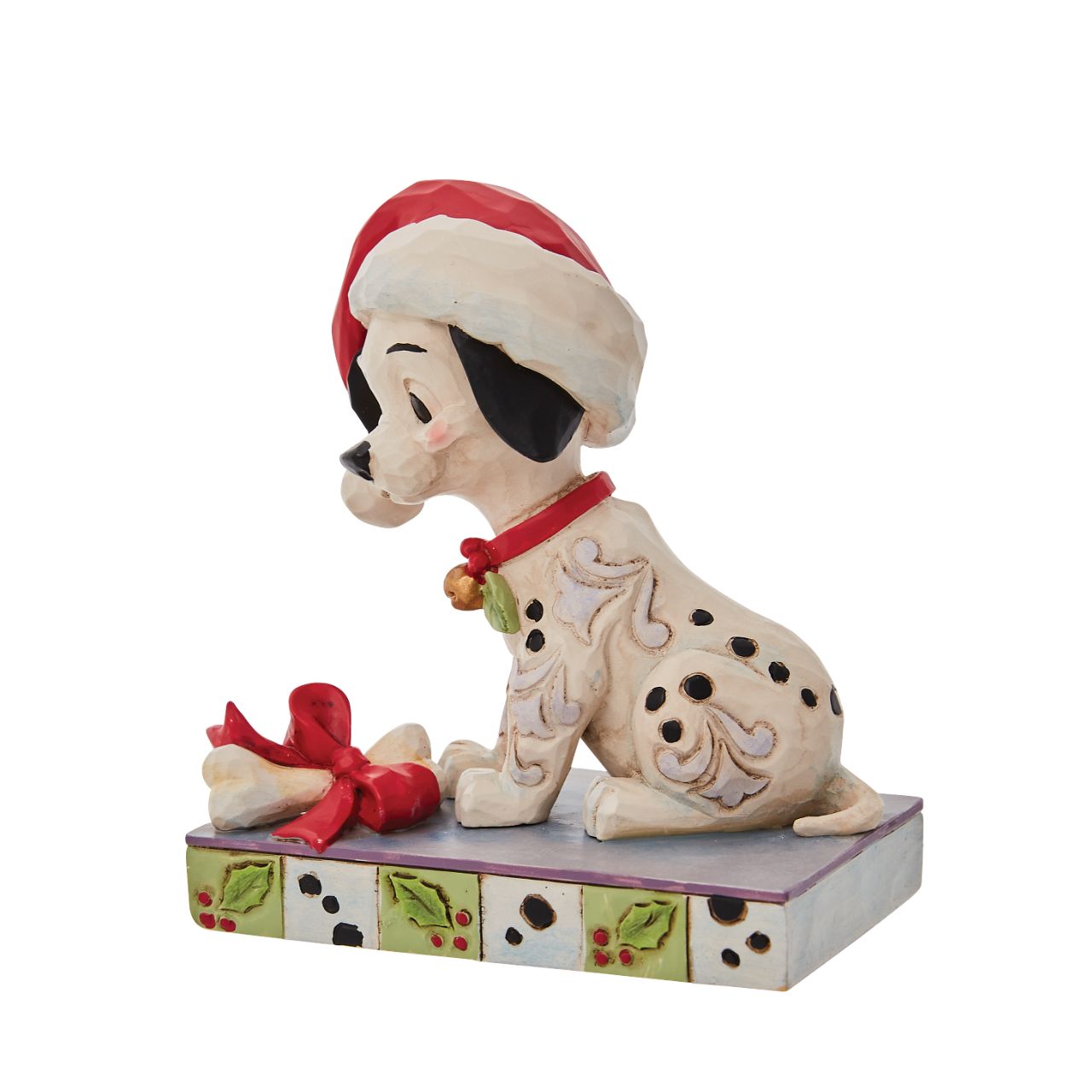 Jim Shore Christmas Lucky Personality Pose Figurine  With one hundred and one brothers and sisters, Christmastime is a delight for Lucky. Enjoying the winter in London, Lucky savours a bone while he wears holly and a Santa hat decked out in Jim Shore's intricate detail.