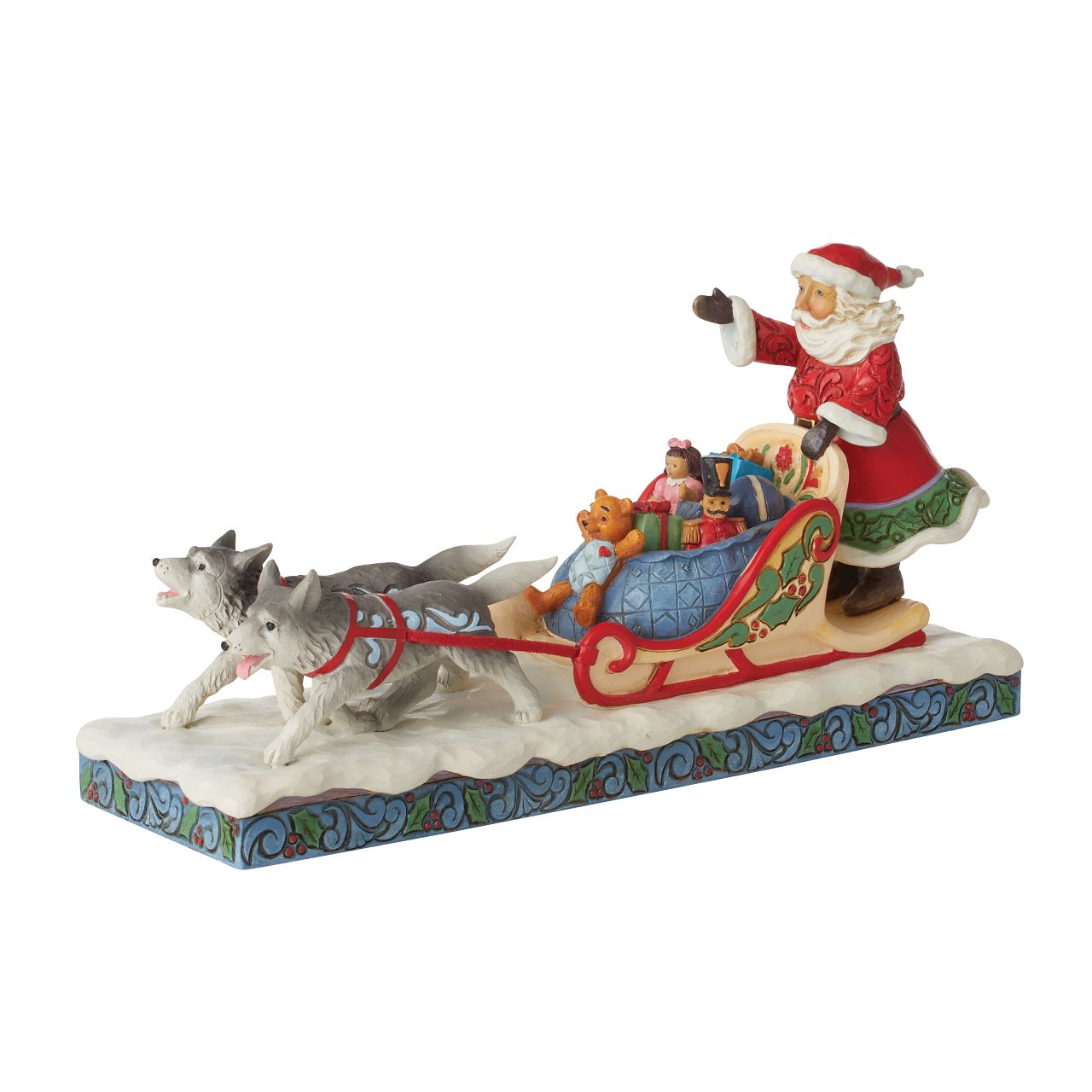 Jim Shore Santa in Dog Sled with Toys Figurine -Heartwood Creek Collection  Wood carved textures and intricately detailed designs. Unique, sometimes surprising combinations of colours - often incorporating a touch of Jim's favourite colour - purple. This magical Santa with sleigh depicts a scene of joy and wonder, Santa delivering his sleigh full of presents to Children all over the world