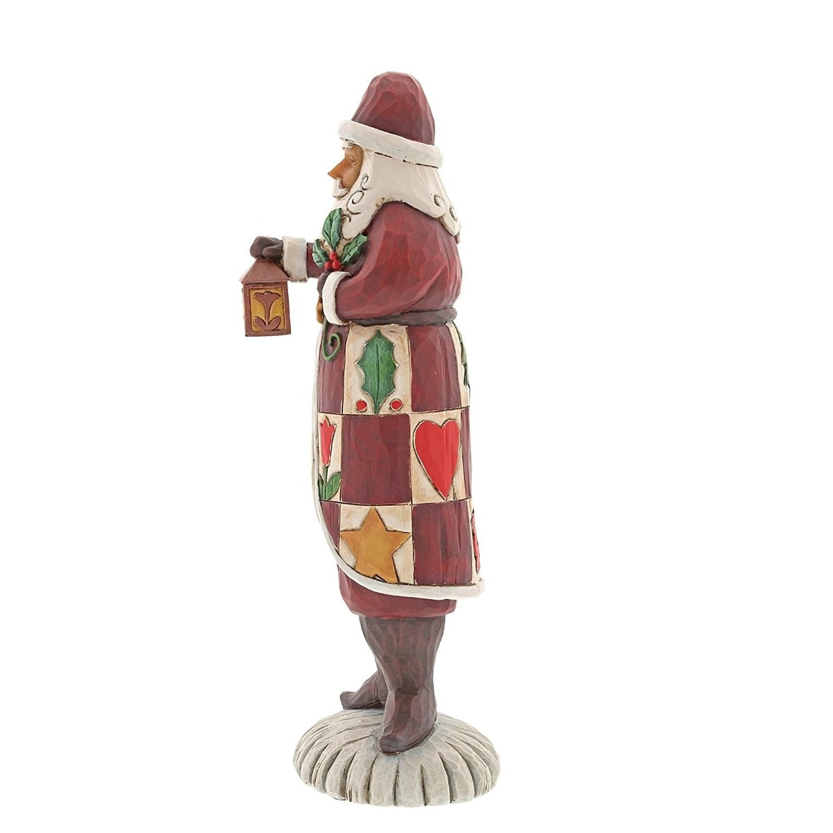 Jim Shore Heartwood Creek Folklore Santa With Lantern  The Folklore collection features Jim Shore's signature colour palette and heartfelt, rustic design. Cloaked in a charming patchwork of quaint holiday symbols, this handcrafted Santa holds a traditional lantern and cheery sprig of holly.