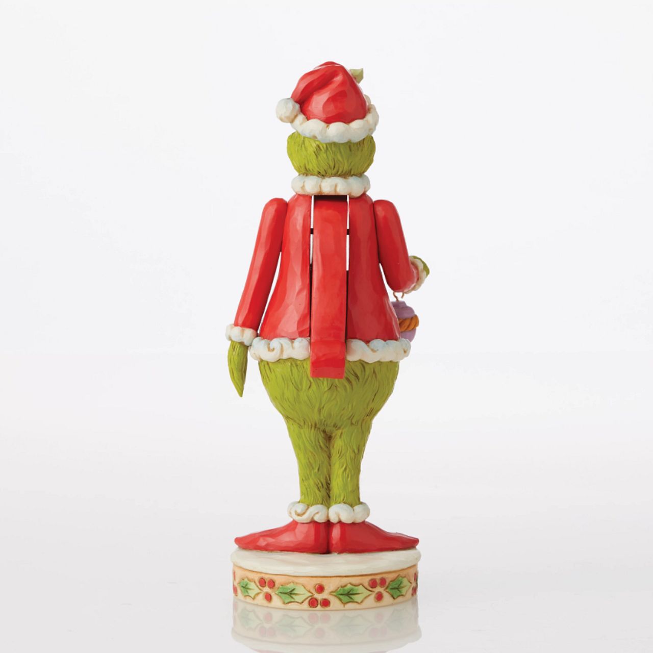 Grinch Nutcracker Figurine - The Grinch by Jim Shore  Marrying two beloved holiday figures, Jim Shore creates a Grinch Nutcracker that captures the grump in all his glory. With holly brimmed in his Santa hat, no one dares kiss this Christmas curmudgeon for fear of being cracked across the face.