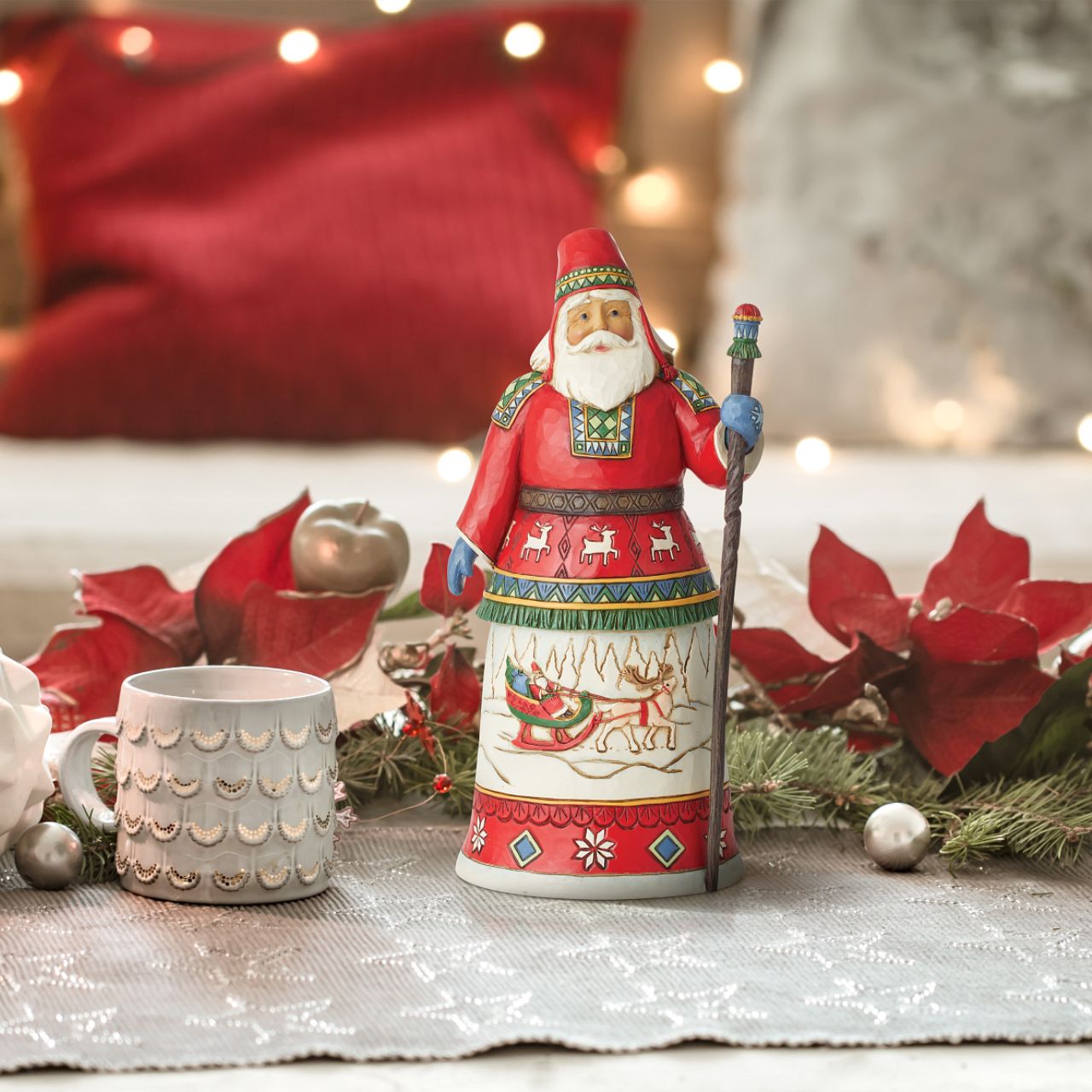 Traditional Heartwood Creek Collection Annual Lapland Santa Figurine  Wood carved textures and intricately detailed designs. Unique, sometimes surprising combinations of colours - often incorporating a touch of Jim's favourite colour - purple. This years annual Lapland Santa showcases a delightful scene of Santa in his Sleigh being pulled by a very proud Reindeer through a magical winter wonderland.