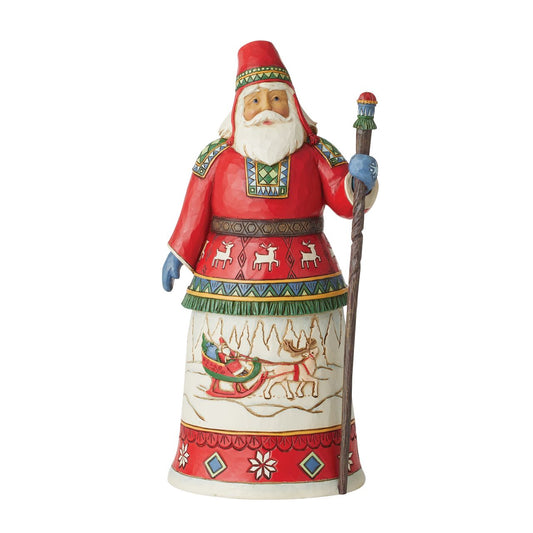 Traditional Heartwood Creek Collection Annual Lapland Santa Figurine  Wood carved textures and intricately detailed designs. Unique, sometimes surprising combinations of colours - often incorporating a touch of Jim's favourite colour - purple. This years annual Lapland Santa showcases a delightful scene of Santa in his Sleigh being pulled by a very proud Reindeer through a magical winter wonderland.