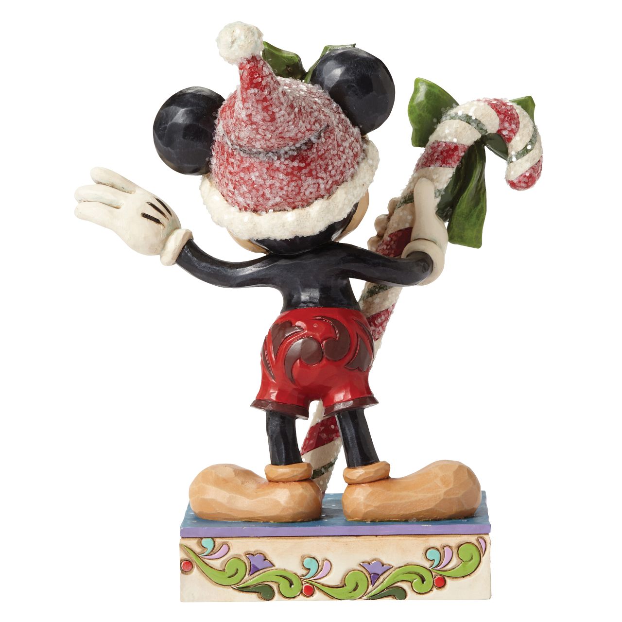 Disney Mickey Mouse Candy Cane Figurine  "Sweet Greetings" A jolly Mickey Mouse brings a gift of sugar coated candy in this delightful Christmas design from the artistry of Jim Shore. Beautifully handcrafted, this eye-catching piece features the classic Disney character decorated in Jim's unique folk art style.