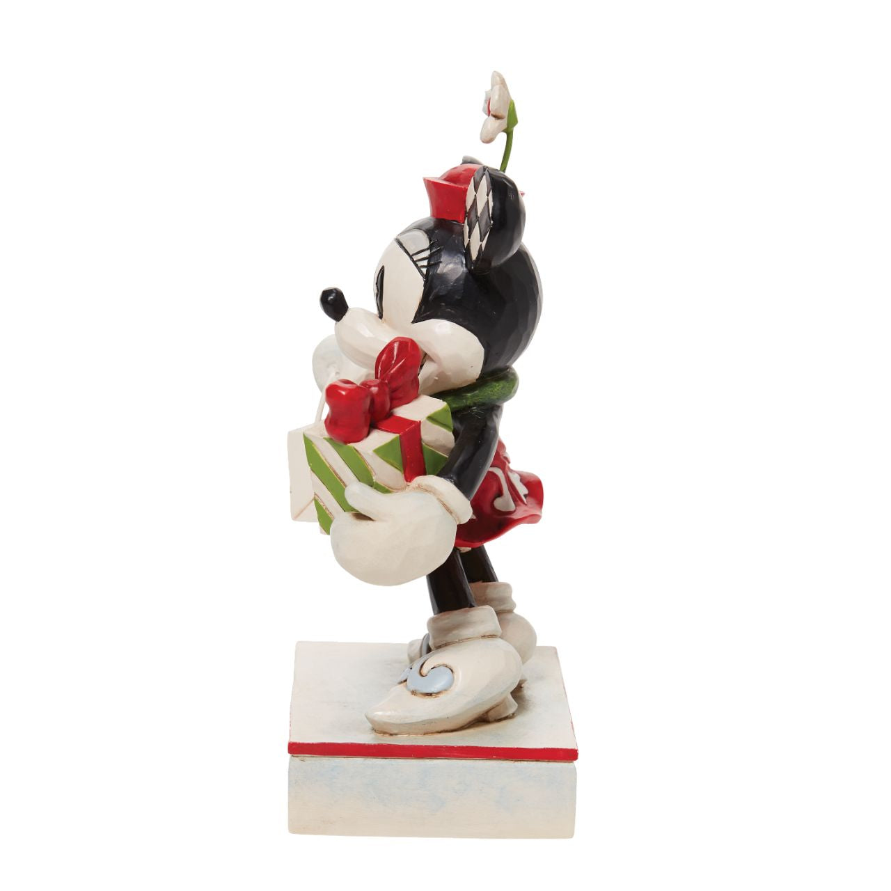 Jim Shore Christmas Minnie with Bag and Present Figurine  Disney comes home for the holidays with this festive figurine by Jim Shore. Minnie Mouse is an icon of fashion and friendliness this year as she completes her Christmas shopping. Boasting with bags, she's eager to share the giving spirit with you.