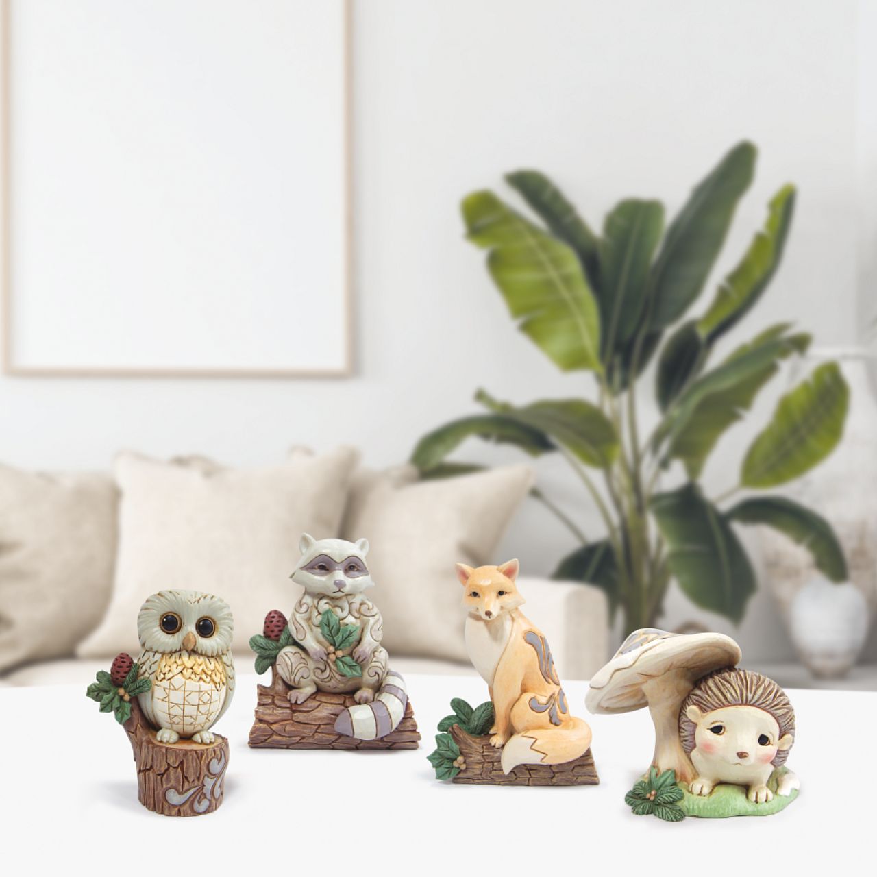 Jim Shore Raccoon with Pinecone Mini Figurine  The White Woodland Collection showcases Intricate Jim Shore designs, with soft neutral colour palette suitable for many styles of home décor. This magical collection on Minatare Figurines is a perfect gift for anyone wanting to start a White Woodland Collection.
