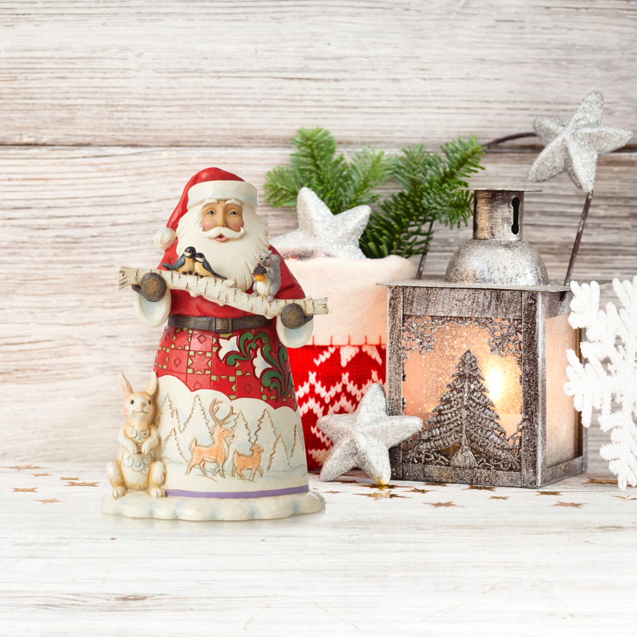 Jim Shore Santa With Birch Branch and Animals Figurine A woodland Santa has a bunny at his feet and holds a birch branch with tiny birds perched on it in this sweet Jim Shore figurine. Santa's cloak features an intricately designed design of deer in a winter landscape. 