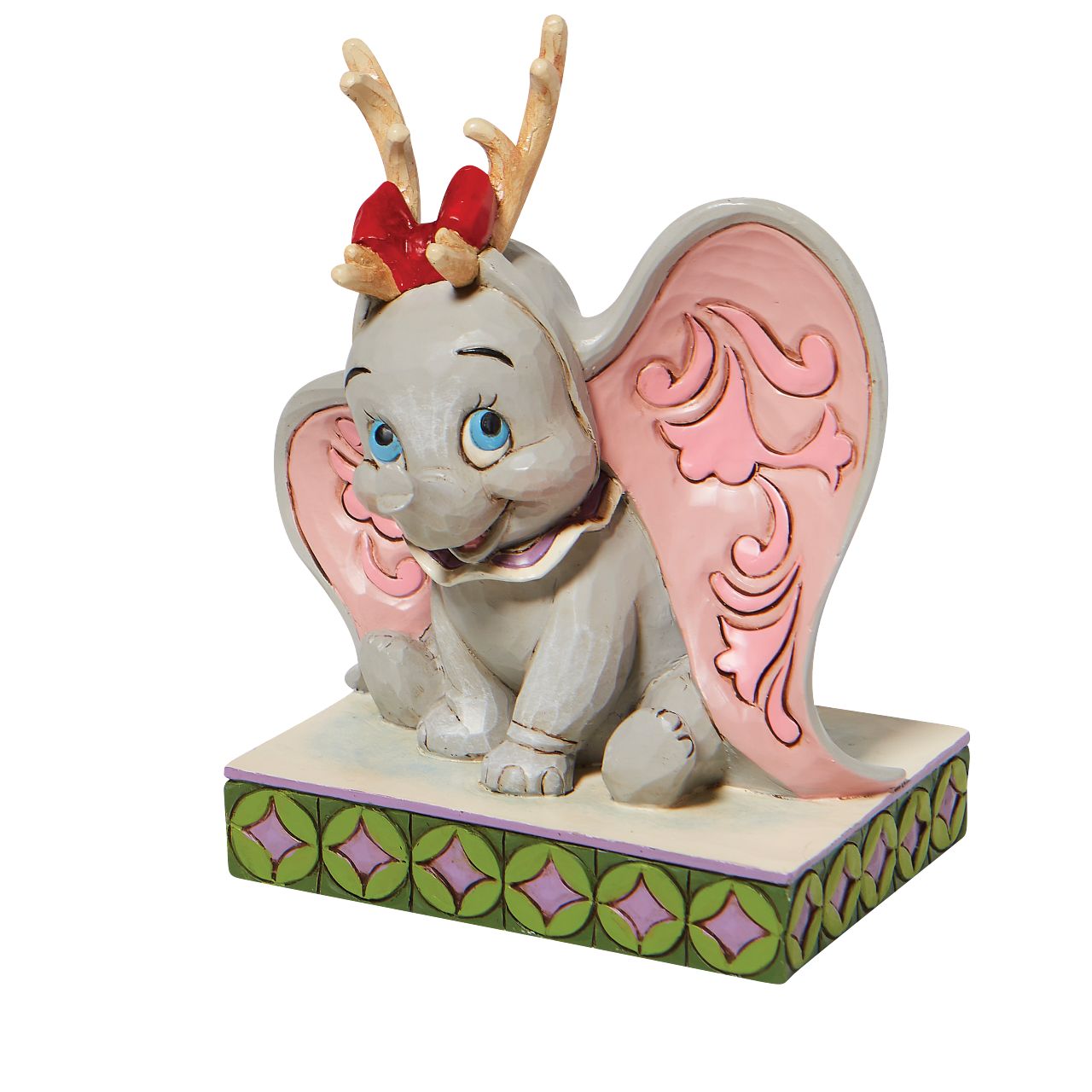 Jim Shore Santa's Cheerful Helper - Flying Dumbo as a Reindeer Figurine  "Santa's Cheerful Helper" Dumbo, the sweetest elephant with the largest ears, dons antlers to help deliver presents this season. Already gifted with the power of flight, he'll make a lovely reindeer for Santa's sleigh in this Jim Shore classic.