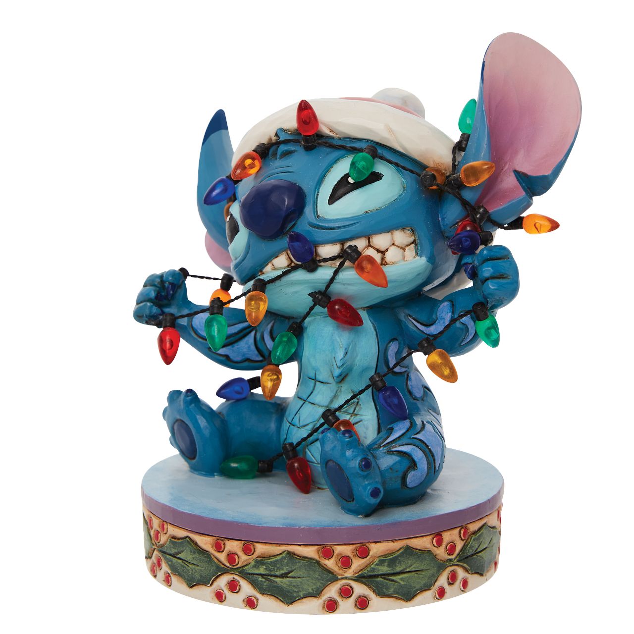Stitch Wrapped in Lights Figurine  Disney comes home for the holidays with this festive figurine by Jim Shore. Attempting to help his Ohana decorate, Stitch gets caught up in Christmas preparations. Tangled in lights, the little alien tries to escape while wearing a Santa hat.