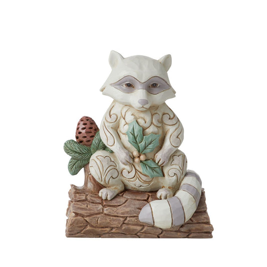 Jim Shore Raccoon with Pinecone Mini Figurine  The White Woodland Collection showcases Intricate Jim Shore designs, with soft neutral colour palette suitable for many styles of home décor. This magical collection on Minatare Figurines is a perfect gift for anyone wanting to start a White Woodland Collection.