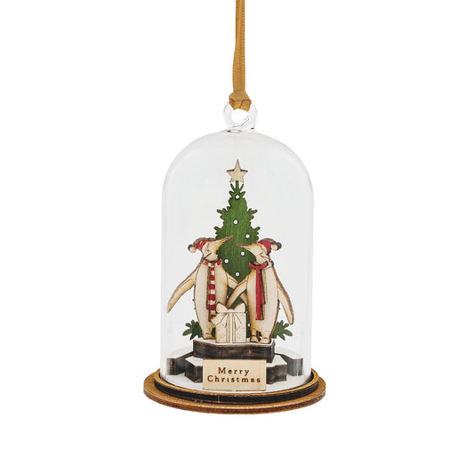 Kloche Merry Christmas Hanging Ornament  The Spirit of Christmas, a collection of delightful wooden decorations that capture the essence of that special time of the year. This glass dome, Christmas decoration encases a cute scene of penguins in their natural habitat.