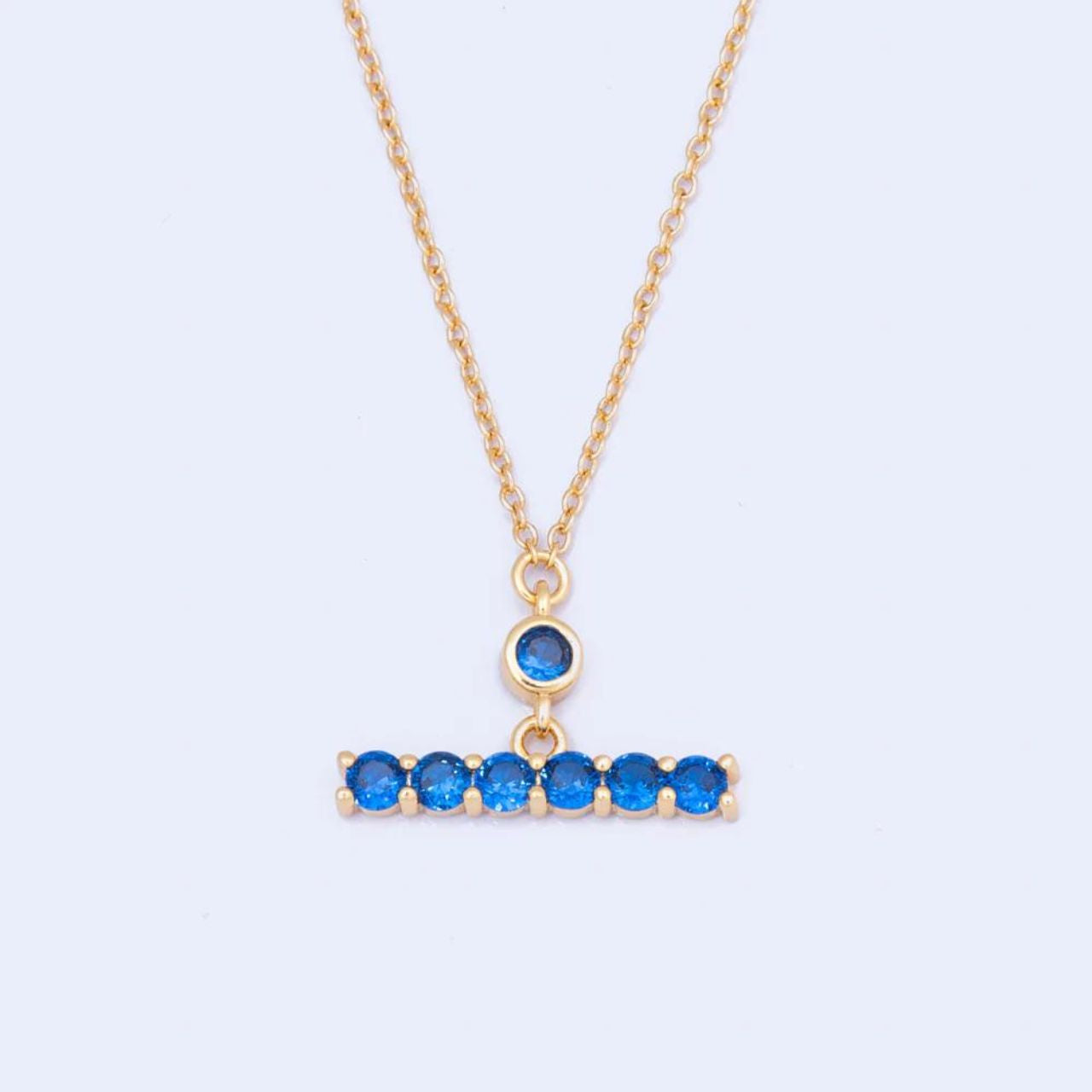 Knight & Day Sapphire T-Bar Necklace  T-Bar necklace embellished with sapphire CZ stones. Gold plating.