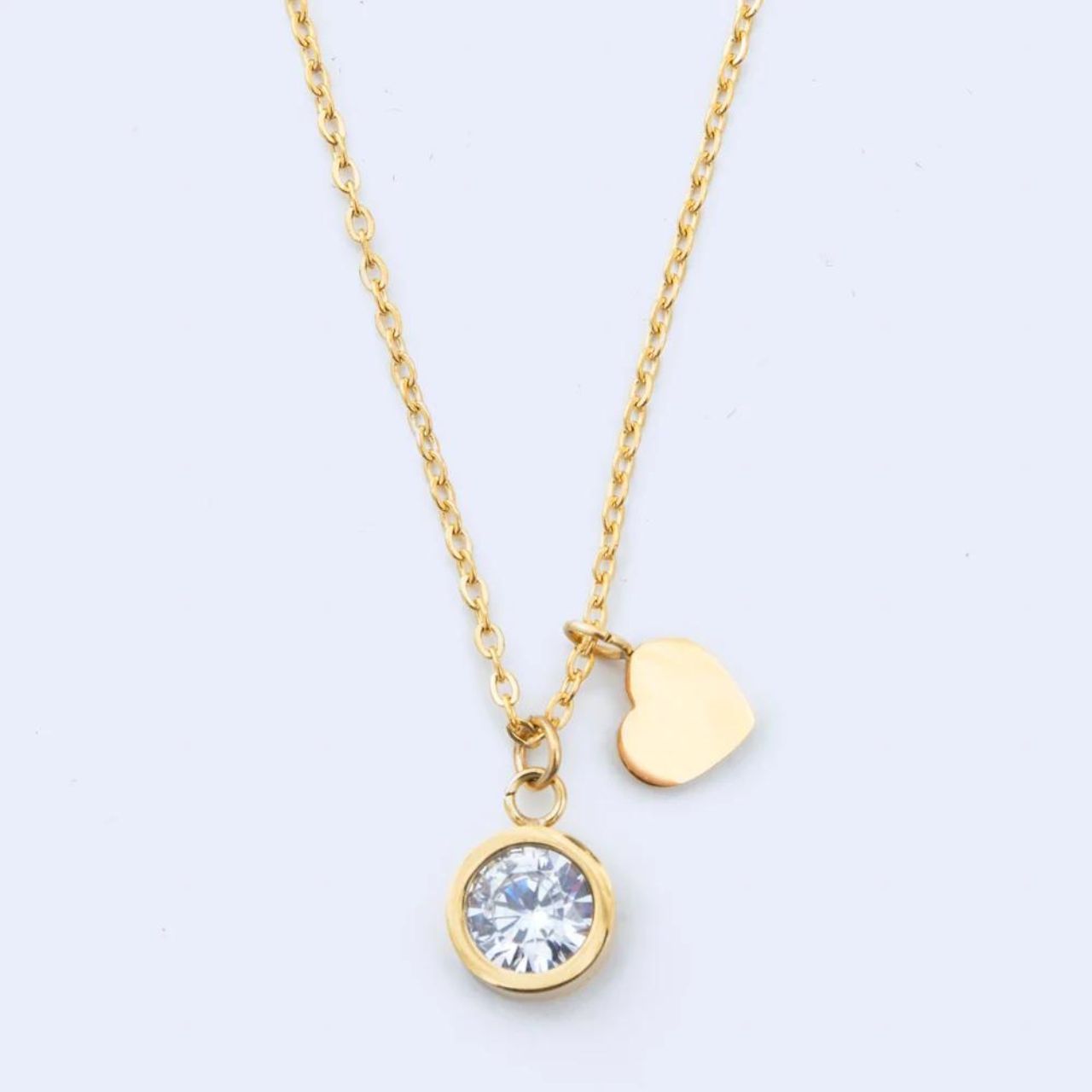 Solitaire Pendant by Knight & Day  Beautiful solitaire with simple heart charm.  Length 41 + 5cm extension. Gold plating.