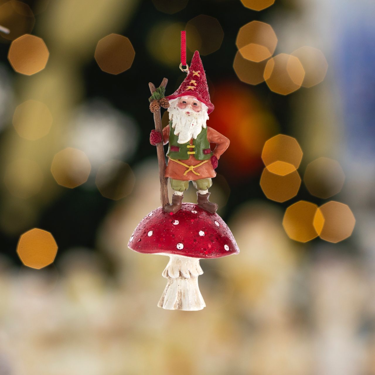 Kurt S Adler Christmas Gnome On Mushroom Ornaments - Standing  Kurt Adler's gnome on mushroom ornaments are a whimsical addition to your holiday décor or Christmas tree. Gnome on a red and white glittered mushroom.