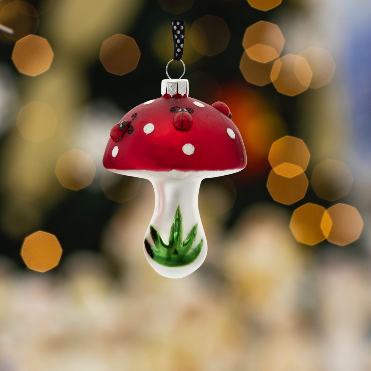 Ladybug On Mushroom Christmas Ornaments - Single Mushroom Head  Kurt Adler's red and white mushroom ornaments are a fun and festive addition to any holiday décor or Christmas tree. Single Mushroom is decorated with green grass and red and black ladybugs.