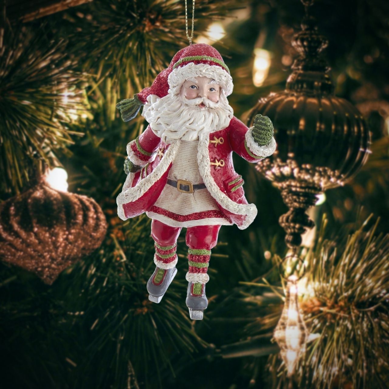 Kurt S Adler Skating Santa Christmas Hanging Ornament - Arm Up  Skating Santa ornament from Kurt Adler is a charming addition to any holiday décor or Christmas tree. Santa wearing a red, white and green Santa outfit with a glittered hat and ice skates.