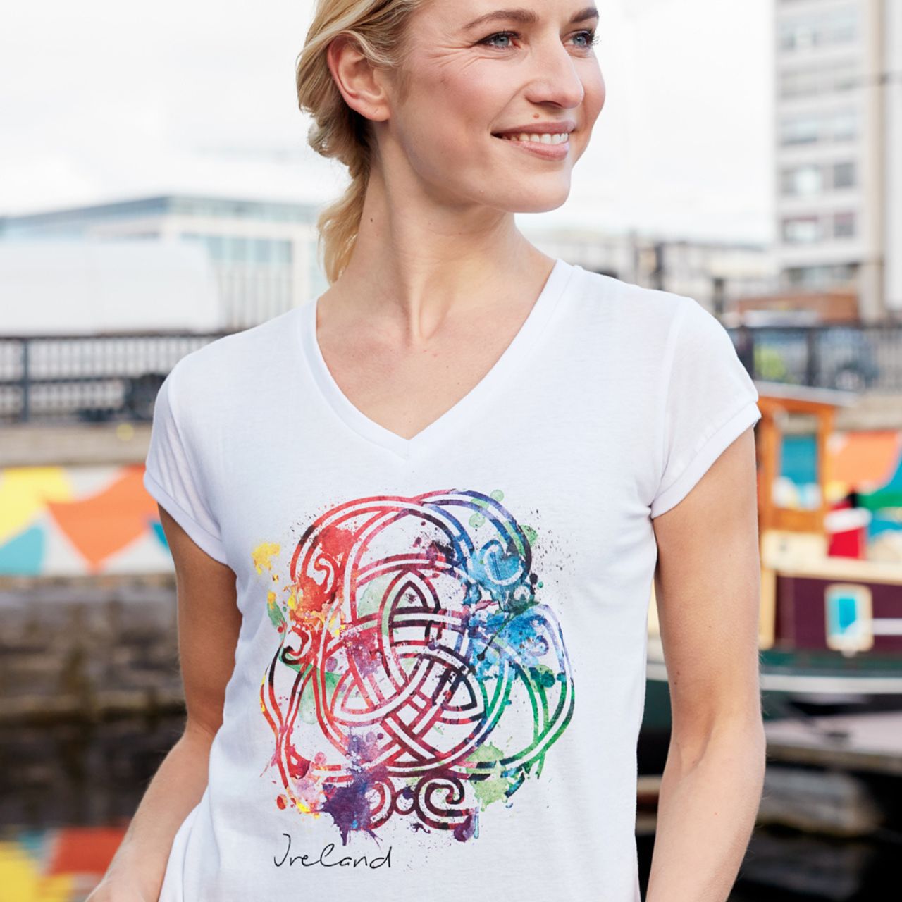 Ladies White Coloured Celtic Knot V-Neck T-Shirt  white ladies V-neck cotton T-shirt is a part of the Traditional Craft Official Collection. The printed multi colour 'water colour' effect Celtic knot give this fitted style T-shirt a unique feel.  100% Cotton