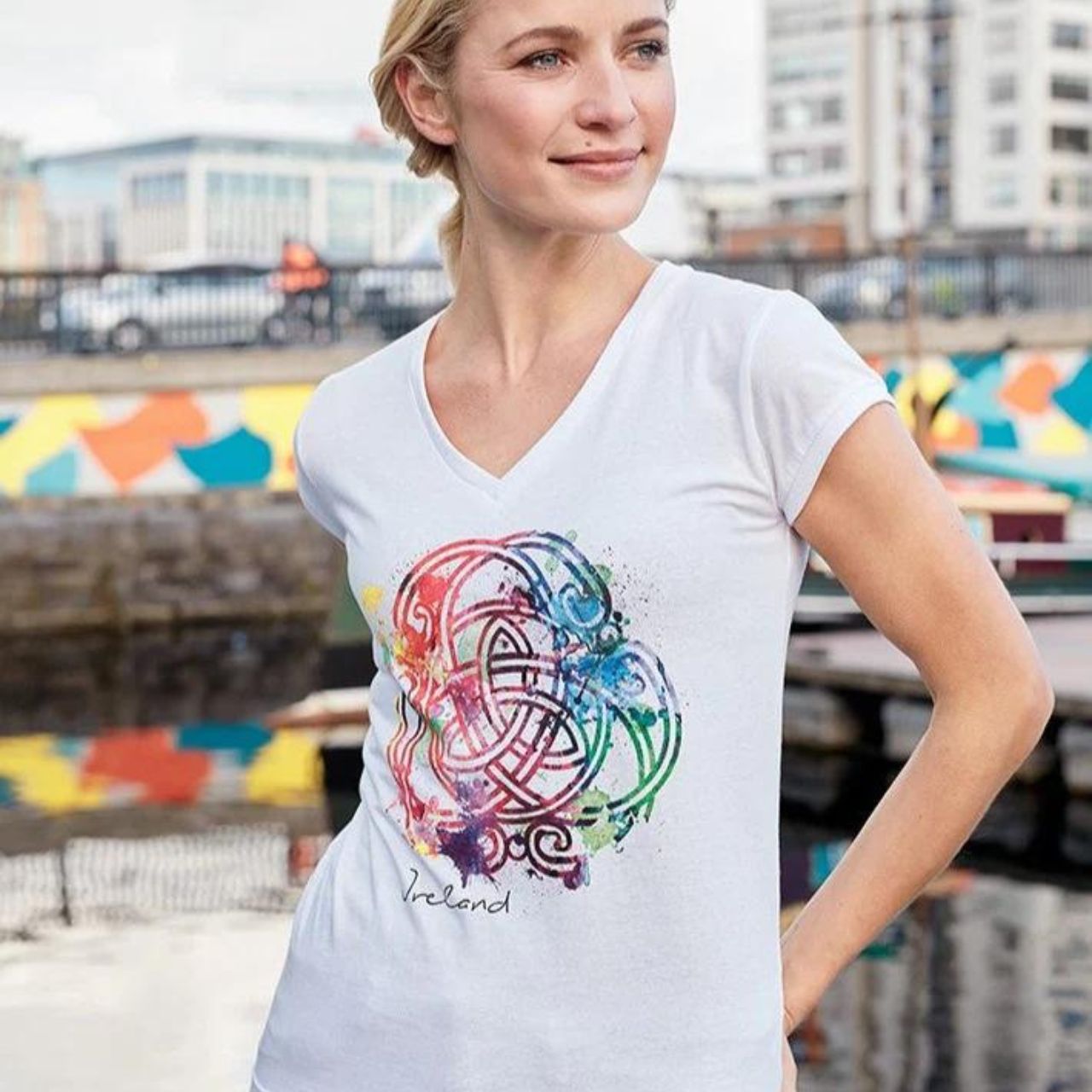 Ladies White Coloured Celtic Knot V-Neck T-Shirt  white ladies V-neck cotton T-shirt is a part of the Traditional Craft Official Collection. The printed multi colour 'water colour' effect Celtic knot give this fitted style T-shirt a unique feel.  100% Cotton