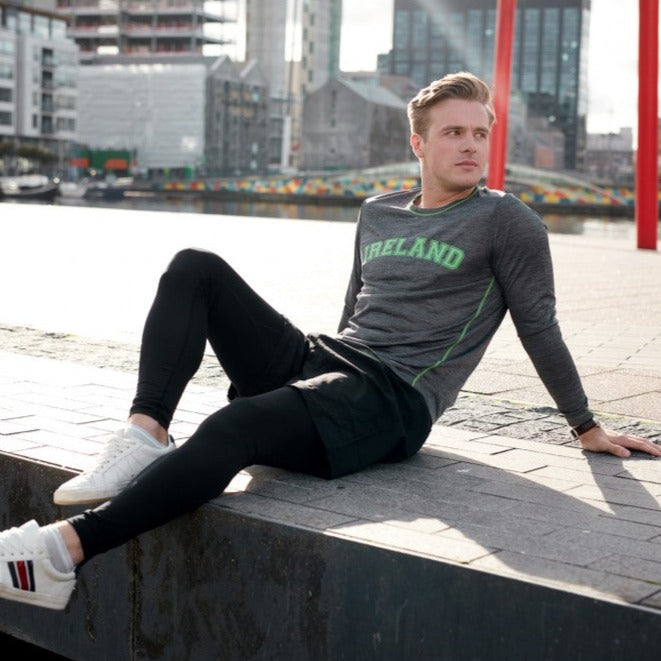 Lansdowne Grey Ireland Long Sleeve Performance Top  Grey performance long sleeve shirt features vivid green stitching with matching text "Ireland" across the chest.  Part of the Lansdowne Collection.  Fabric: Drylan's Performance Dry Fit Performance  Stabilizes core temperature, draws moisture away from the skin, enhances breathability and comfort, improves hydration and circulation, and aids peak performance.