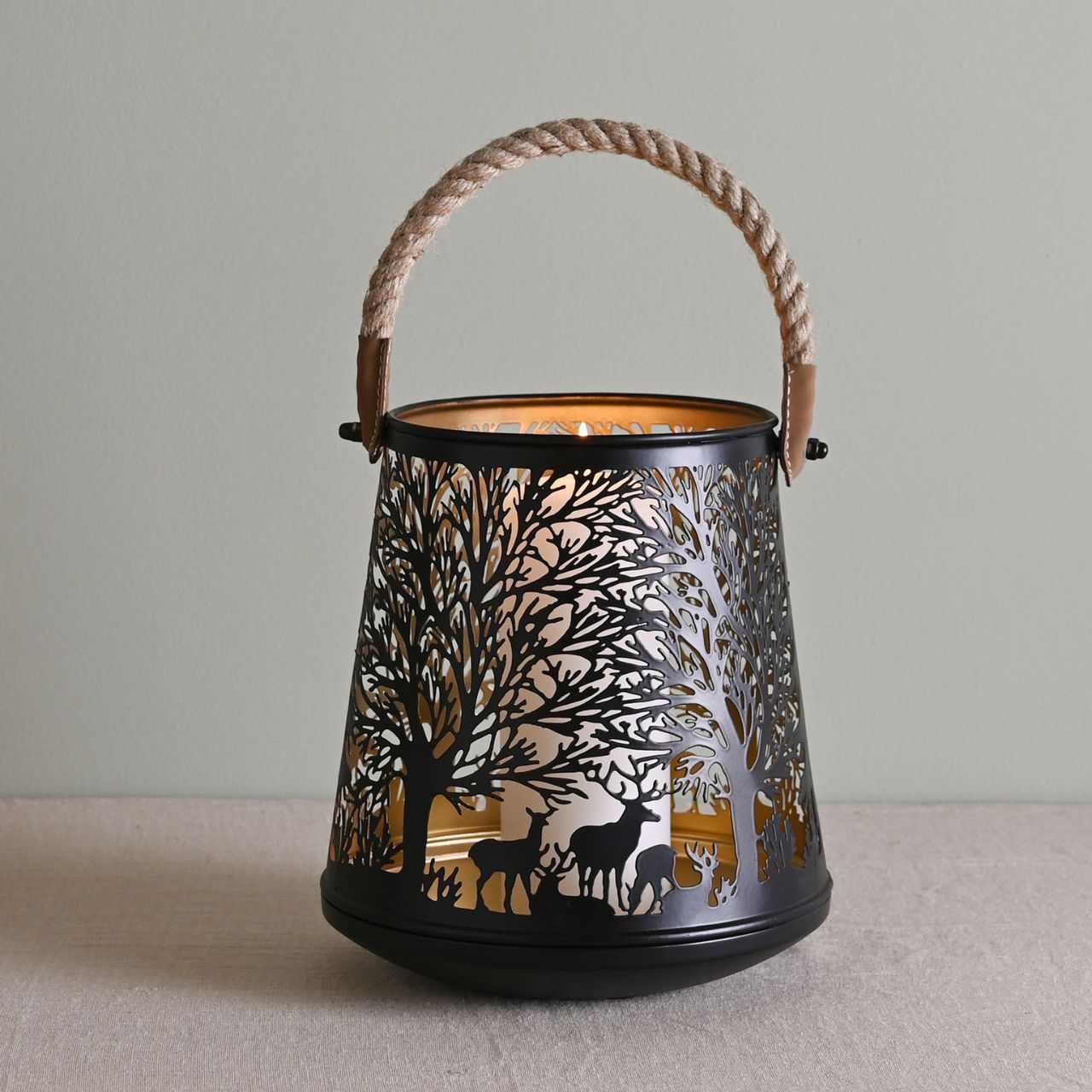 Deer Silhouette Christmas Lantern with Rope Handle  A deer silhouette lantern with rope handle.  This enchanting lantern glistens with festive charm throughout the Christmas period.