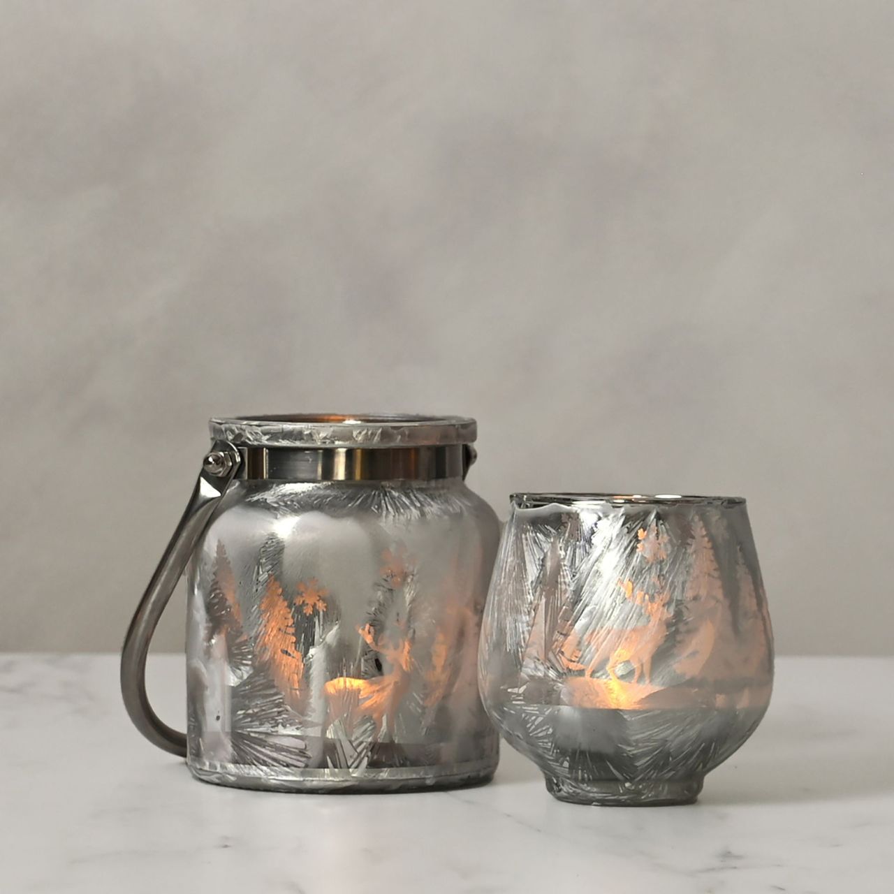 Christmas Frosted Reindeer Forest Scene Lantern with Handle  A frosted reindeer forest scene lantern with handle.  This enchanting lantern glistens with festive charm throughout the Christmas period.
