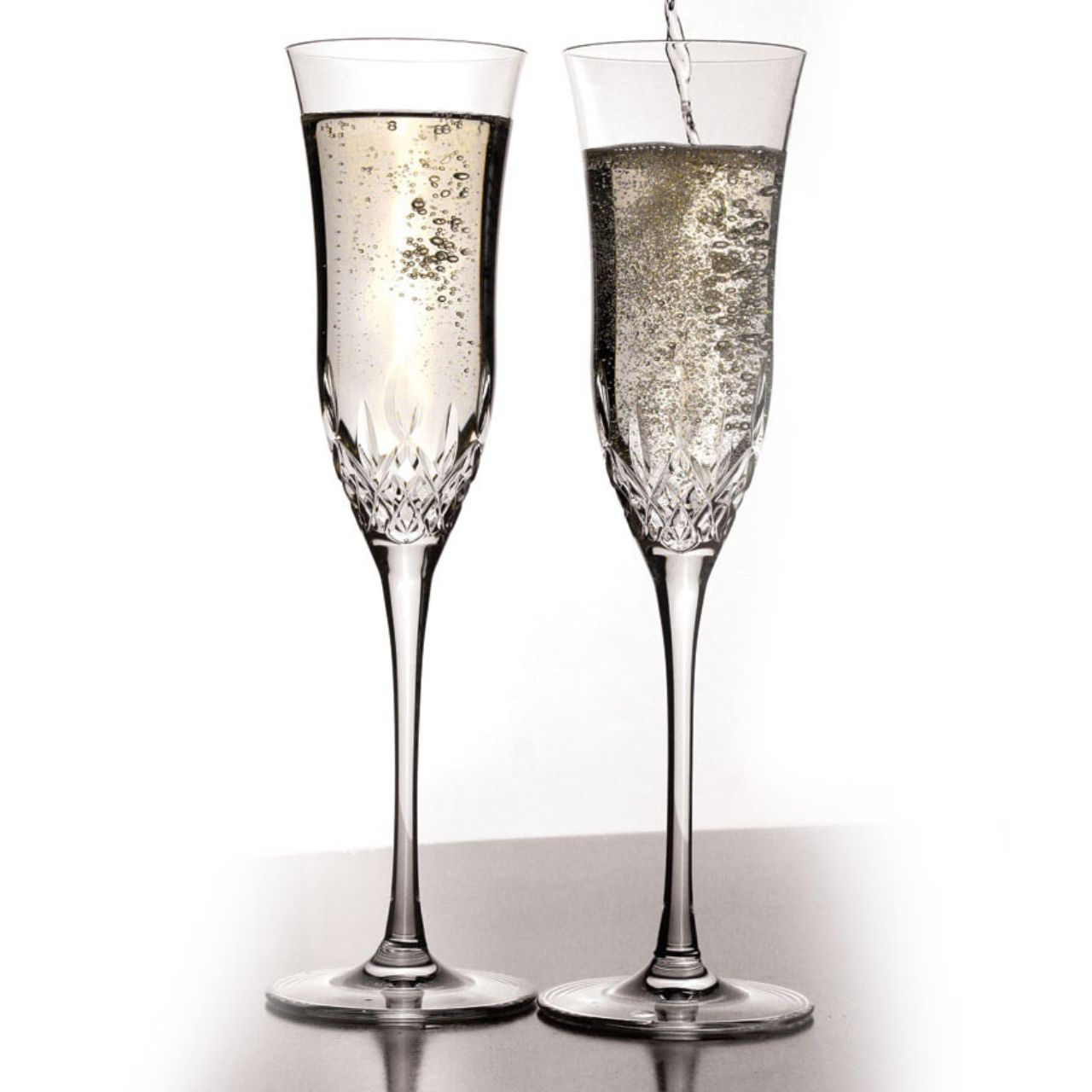 Lismore Essence Champagne Flute Pair by Waterford Crystal  Bring sheer excellence to your celebrations with our pair of Lismore Essence Champagne Flutes : an elegant, contemporary statements that provides the perfect serve for sparkling wine, mimosas, spumante or champagne cocktails.