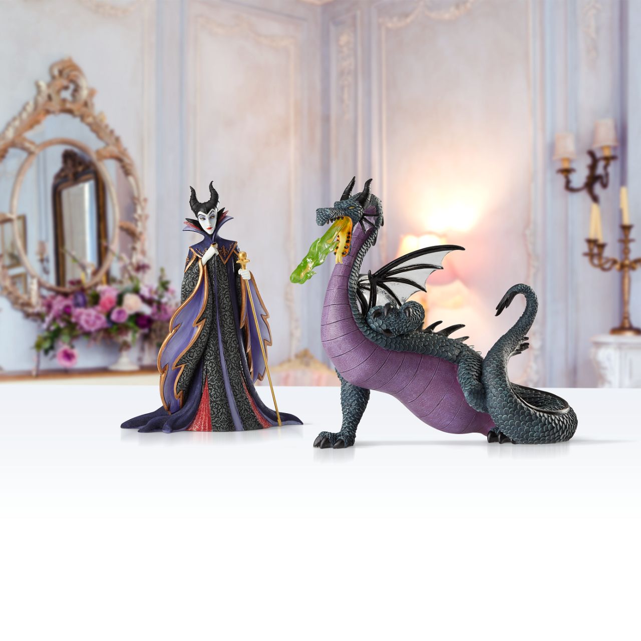 Disney Maleficent Figurine  Maleficent strikes a regal pose in this handcrafted design from the Haute Couture collection, her ominous onyx robes reimagined as a satin gown and feathered, floor-length cape. Ready to rule the runway, the fashionable figure holds a golden scepter.