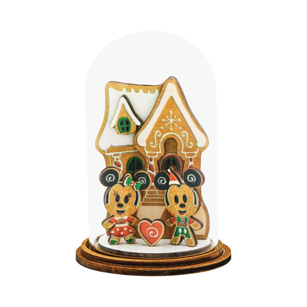 Home for Christmas Mickey and Minnie with Gingerbread House Kloche  Mickey and Minnie Mouse share their love for Christmas time in front of a cute gingerbread house and create a wonderful magical, family moment in this delightful wooden figurine. This gingerbread inspired decorative Kloche will make a stunning display in your home.